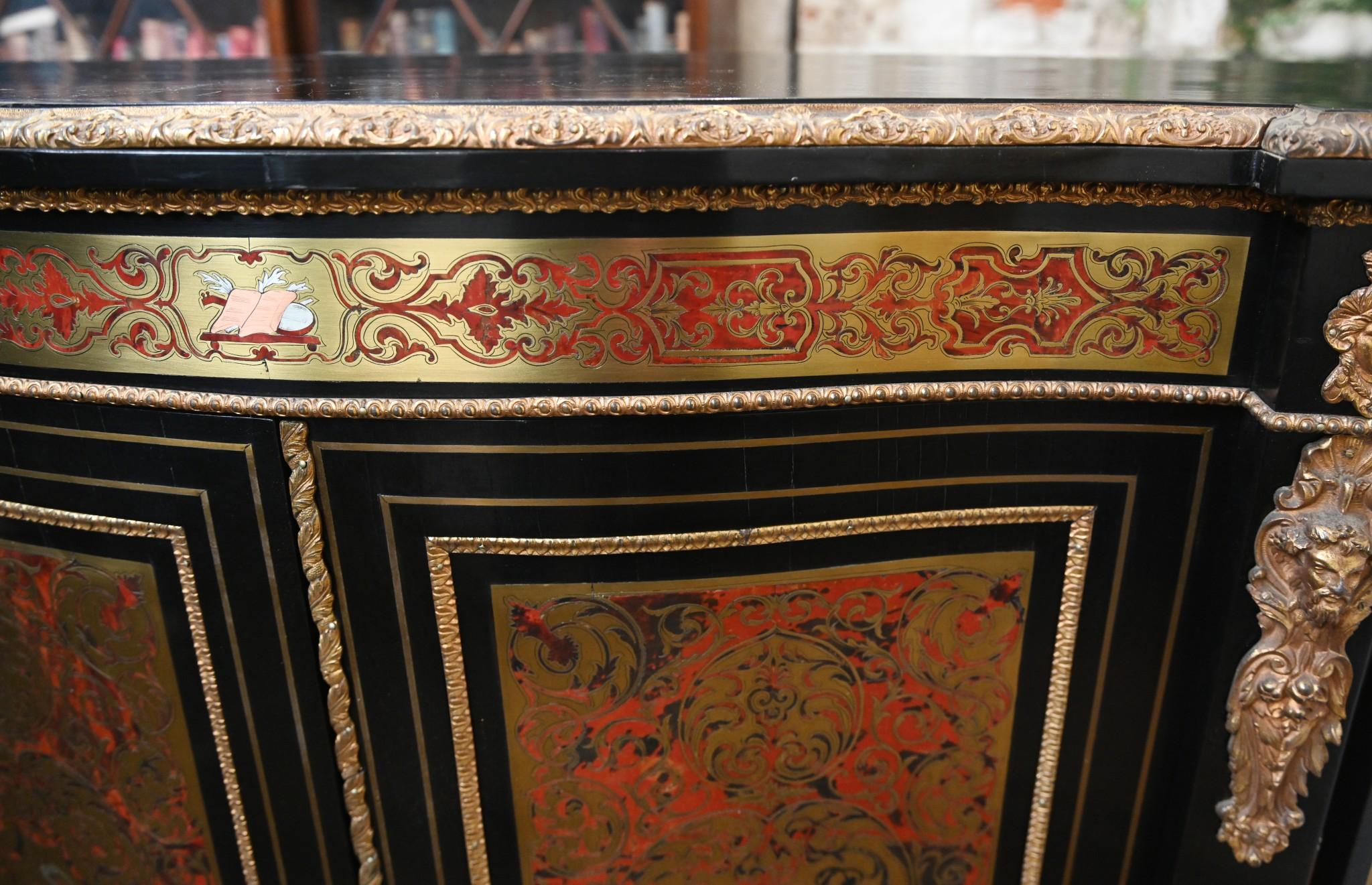 You are viewing a gorgeous large French credenza in the Boulle manner
We date this piece to circa 1860 and it features the classic Boulle style inlay on all surfaces
Two doors in middle open out to reveal cabinets and then two glass fronted side
