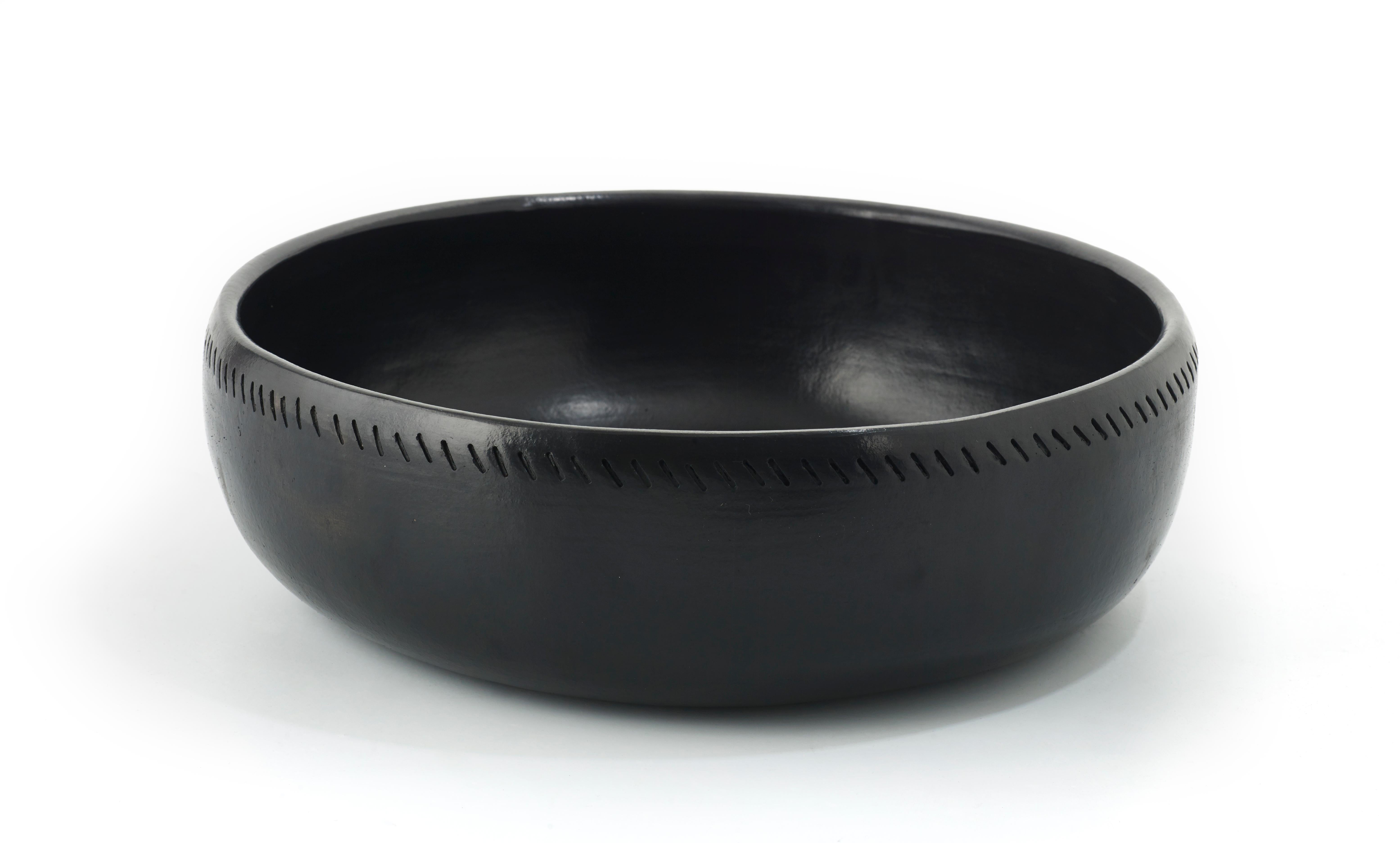 Large bowl barro dining by Sebastian Herkner
Materials: Heat-resistant black ceramic. 
Technique: Glazed. Oven cooked and polished with semi-precious stones. 
Dimensions: Diameter 38 cm x height 12 cm 
Available in sizes: Medium, small, and X small.