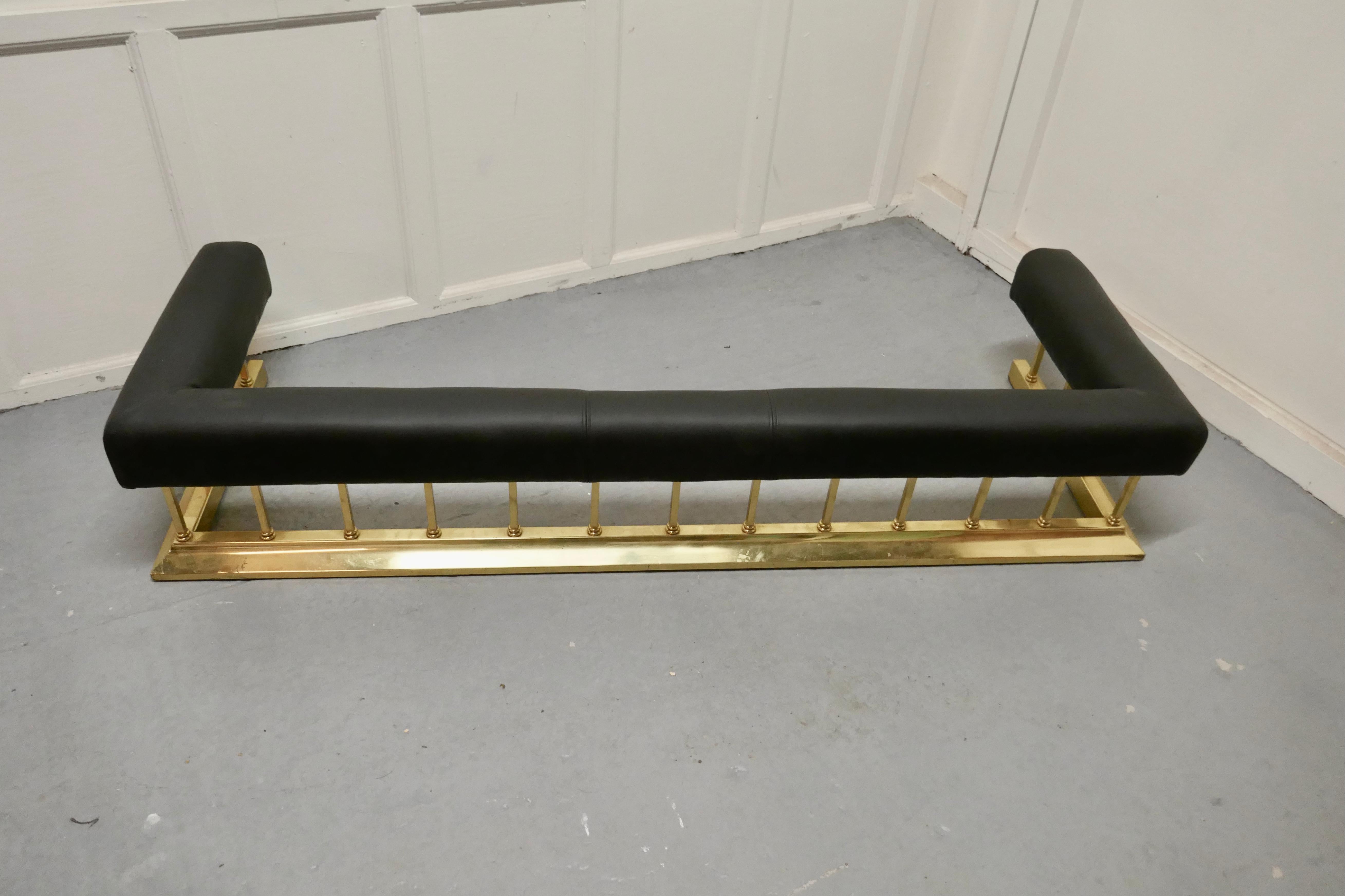 Large brass and black leather step over club fender

This is an unusual piece of country House Furnishing, it is lower than the usual Club Fender, just the right height for attending to the fire without reaching too far
The soft black leather