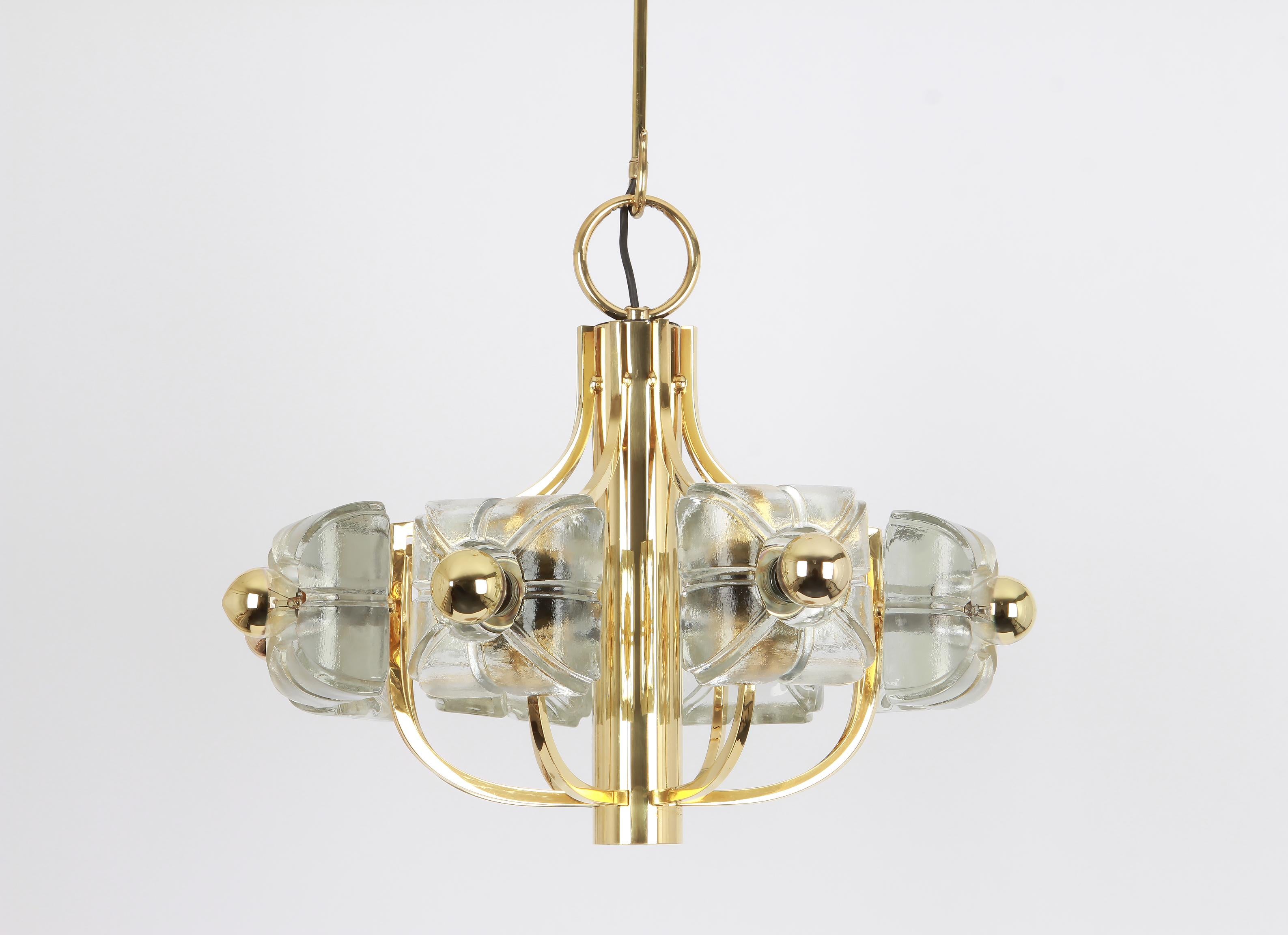A wonderful large and high-quality gilded chandelier/pendant light fixture by Sische, Germany, 1970s

It is made of a brass frame decorated with 8 crystal glasses.
The lamp takes 8 small base bulbs (max. 40W per bulb). And function on a voltage