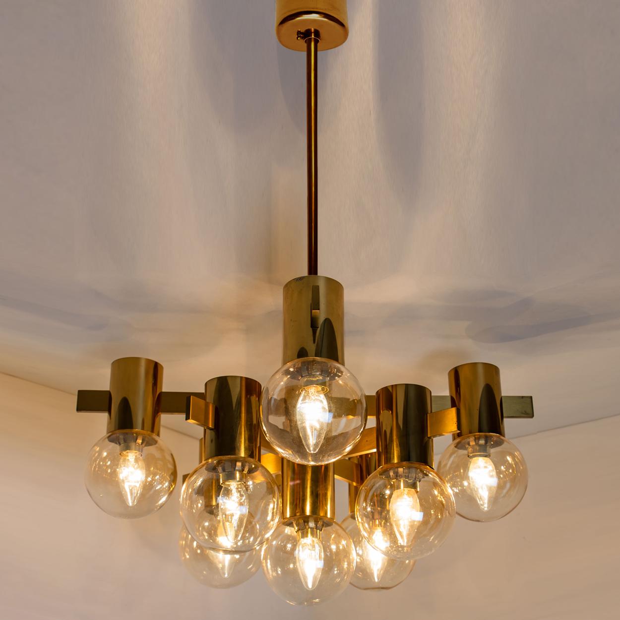 This stunning large brass light fixture with smoked glass bowls and gold-plated fittings was produced in the 1970s in the style of Hans-Agne Jacobsson. Illuminates beautifully.

Size of the chandelier:
D 23.6 in. (60 cm) x H 13.8 in. (35 cm).