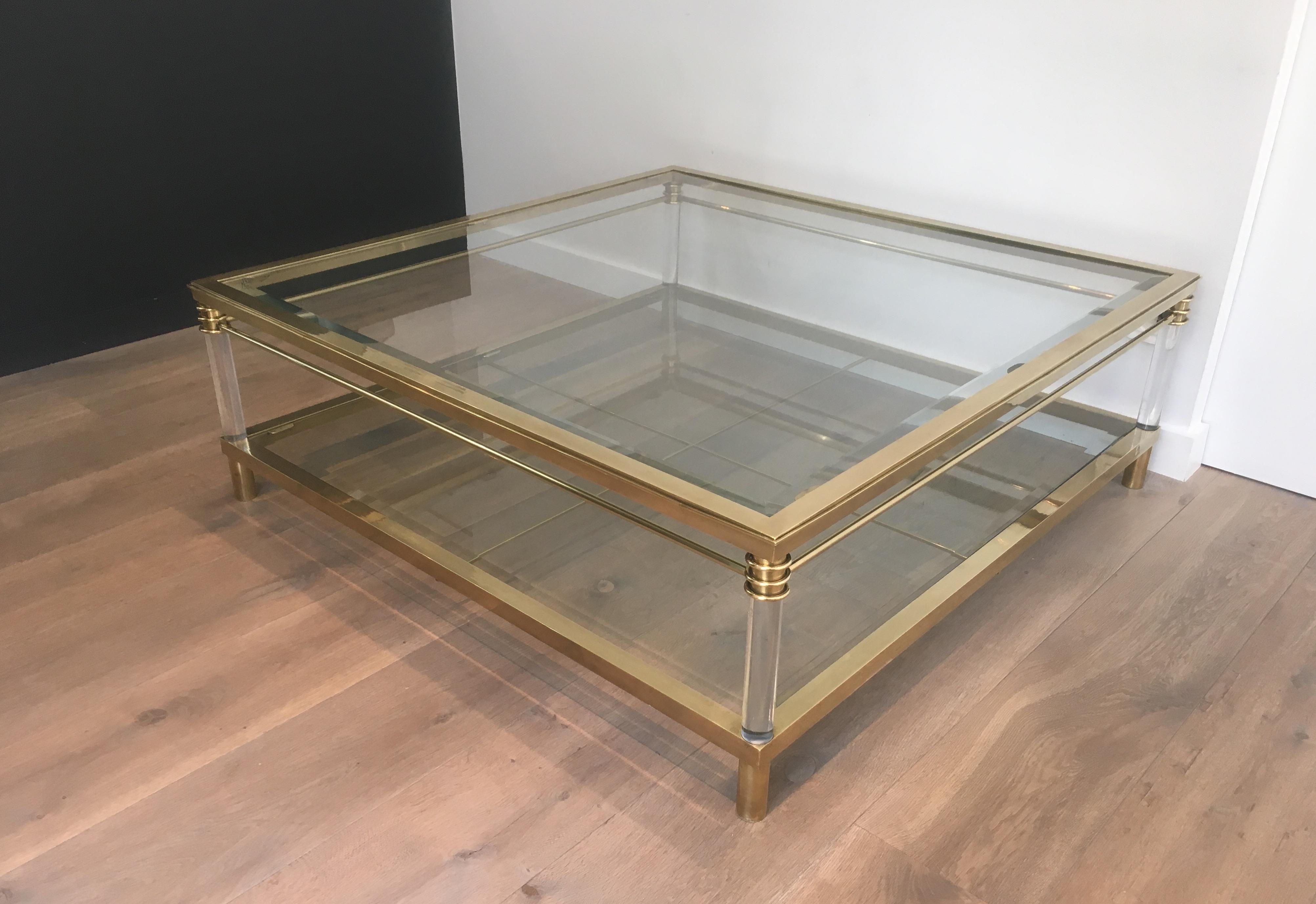 This rare and large square coffee table is made of brass and Lucite. This is a very nice model, very elegant and fine. This is a French work from 1970s.