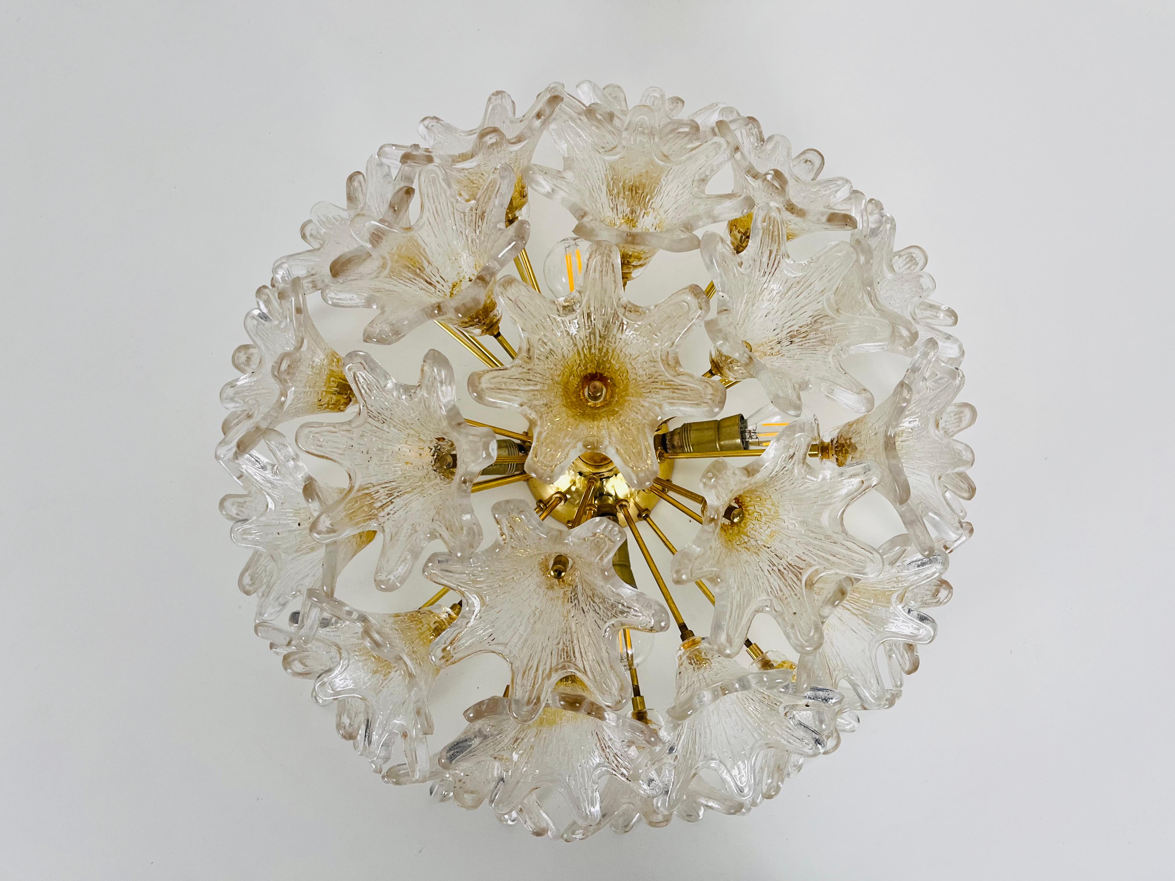 An extraordinary flushmount by Paolo Venini for VeArt made in Italy in the 1960s. The glass elements have a beautiful flower shape and are made of murano glass. The body of the lighting is made of polished brass.

The light requires E14 light