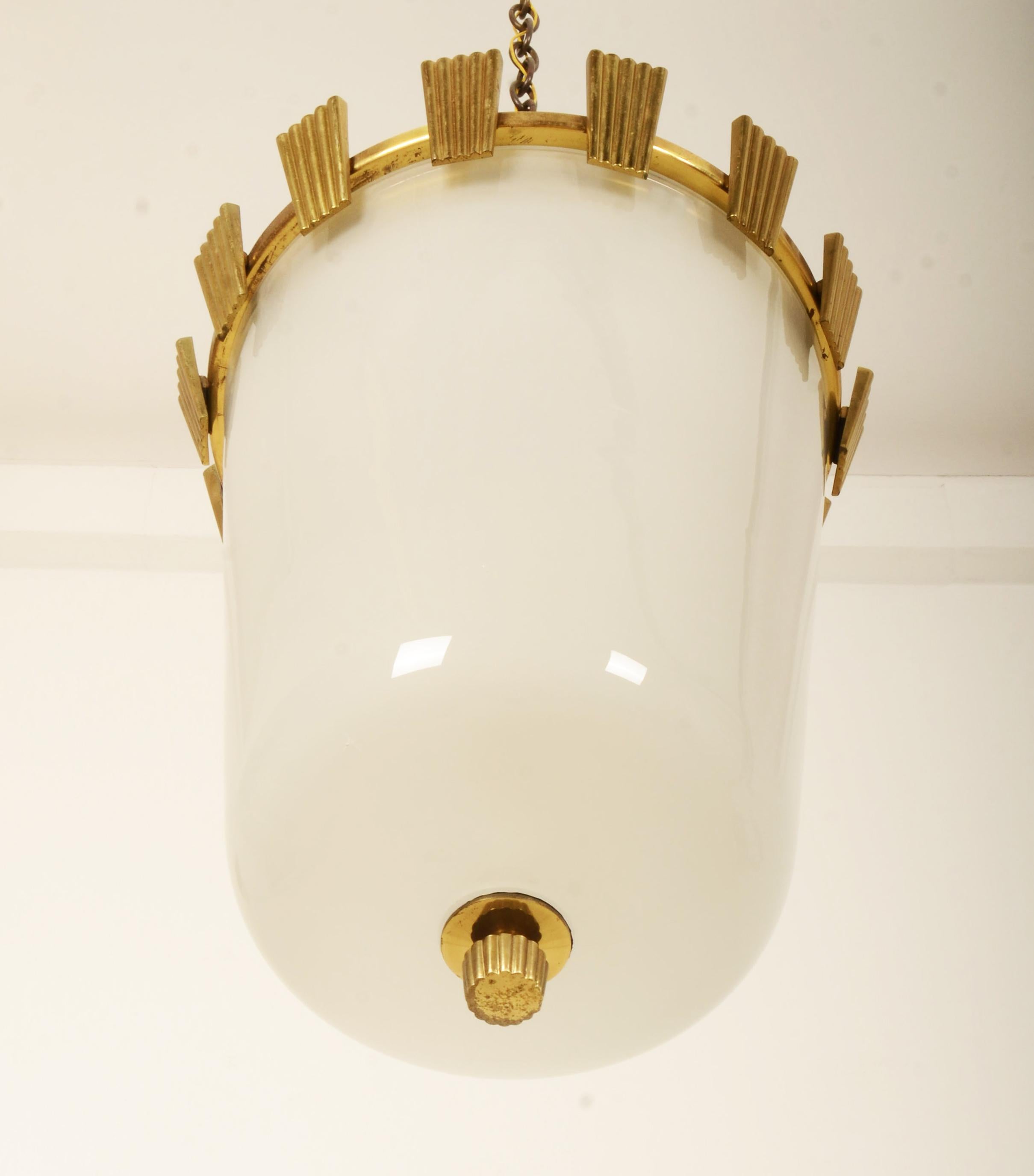 Brass frame with opaline glass shade, fitted with one E27 socket up to 200W. Designed by Oswald Haerdtl in the 1950 for J.T. Kalmar. The lamp was created especially for public places like the Vienna State Opera (see the last 2 pictures) 
The