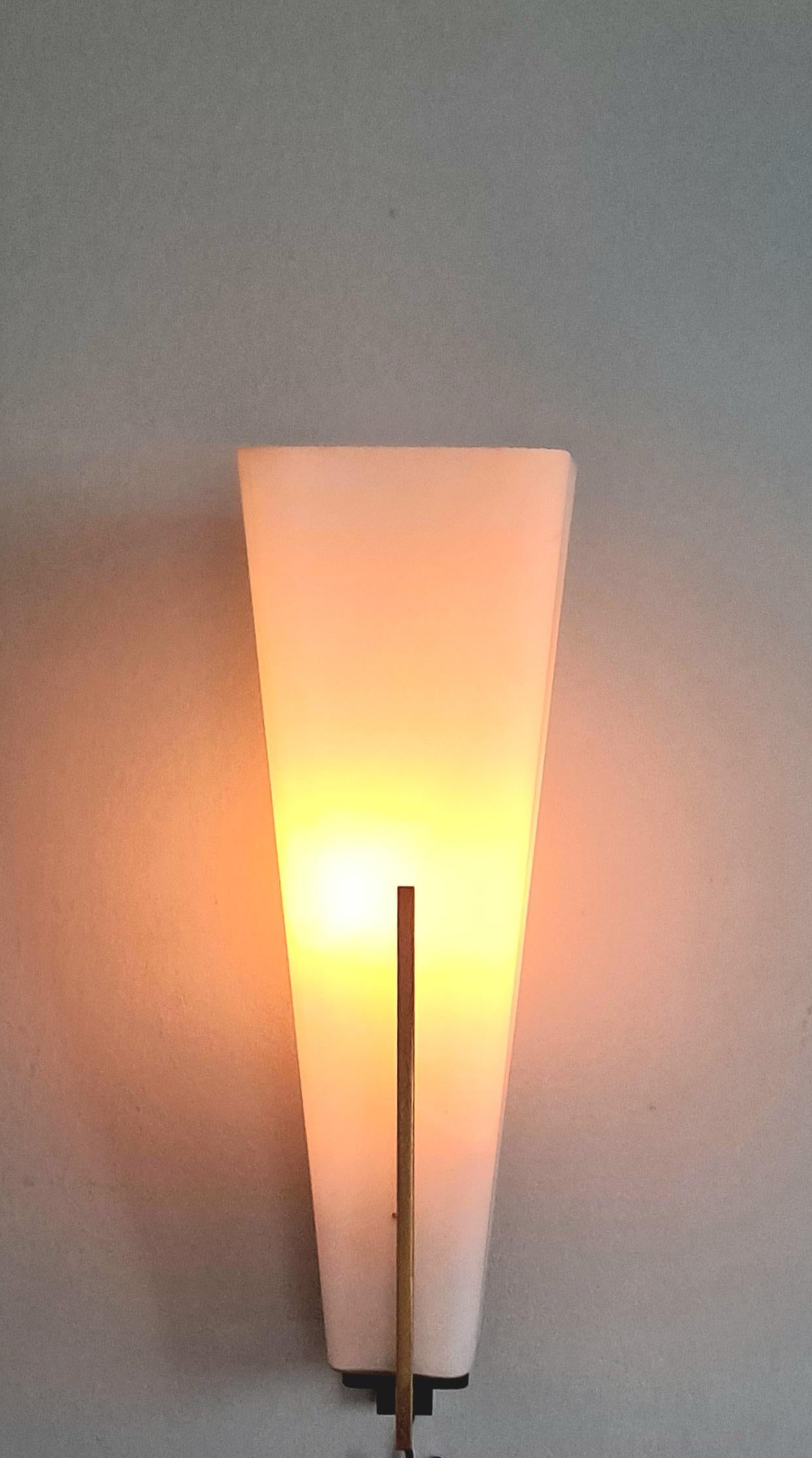 1950 s Large Brass and opaline wall sconce. Wall sconce is typical Italian simple line designee  from 1950 s .Tarnish brass and tick opaline glass. 
