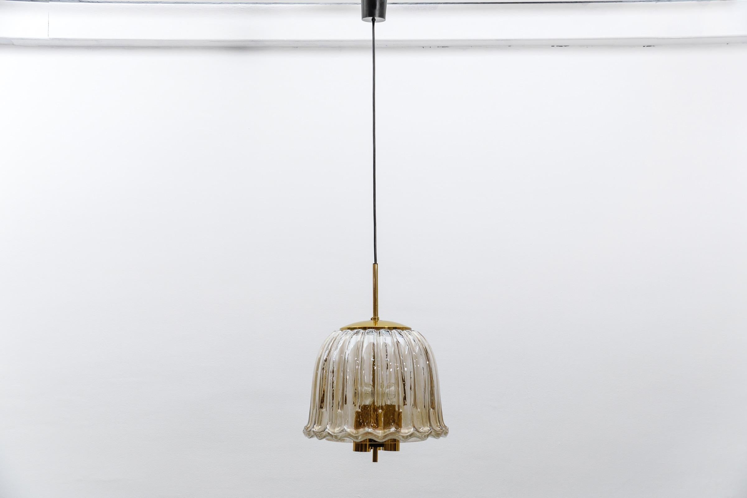Large Brass and Smoked Glass Ceiling Lamp from Limburg, Germany, 1960s

The lamp can be shortened to a total hanging height of 60 cm.

The lamp is executed with three E27 Edison screw fit bulbs. It is wired, and in working condition. It runs both on