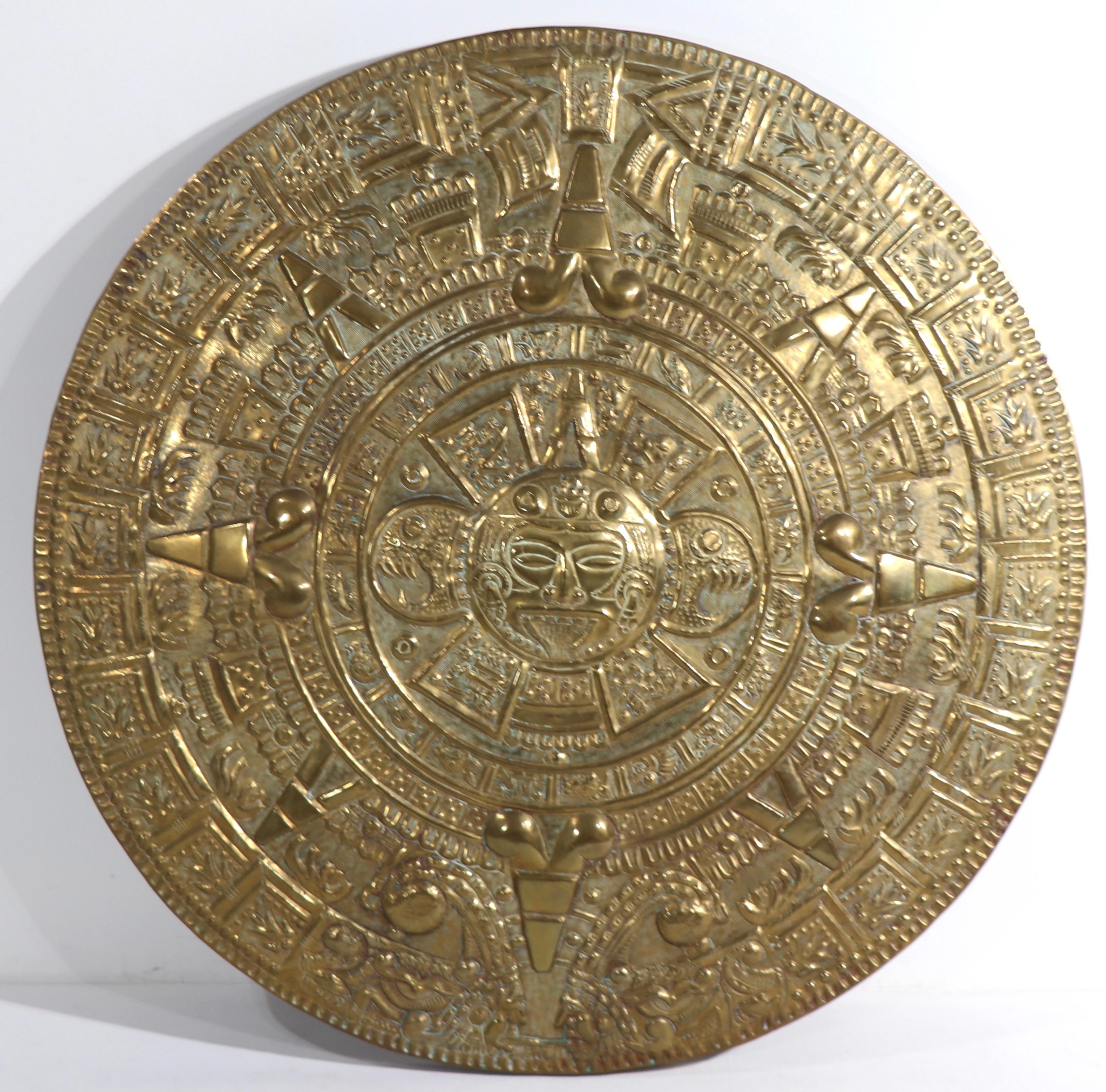 Intriguing brass wall hanging depicting the Aztec calendar, in repousse brass relief.
Perfect decorative accent piece for a Brutalist, or eclectic interior. This unusually large ( 41in. Día.) example is in excellent original condition free of