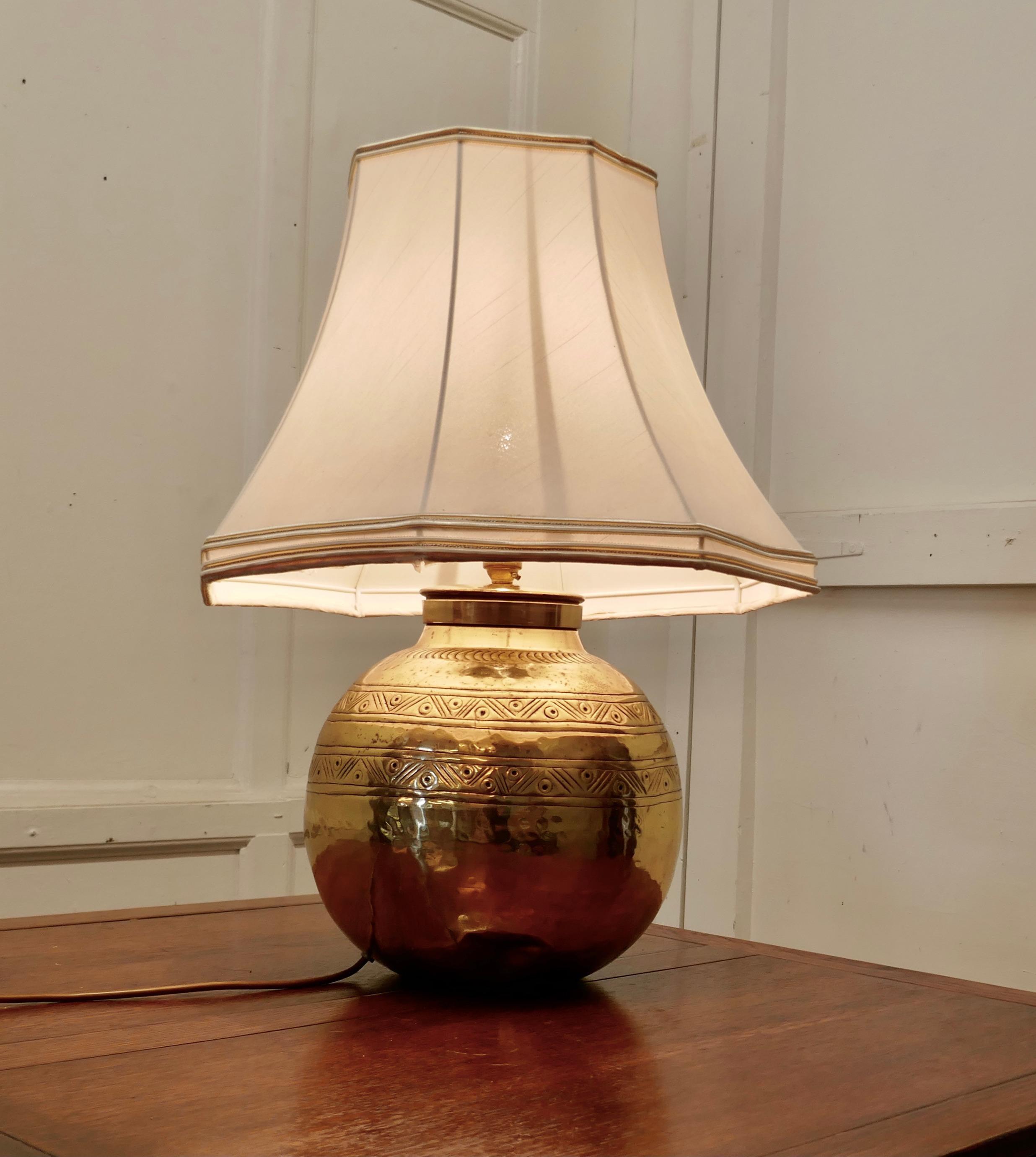 Large brass ball table lamp with hand beaten decoration

This is an unusual Lamp it has a globe shape and has hand beaten decoration around giving it an Ethnic look

The lamp is fully wired and has good natural aged patina, a statement piece in