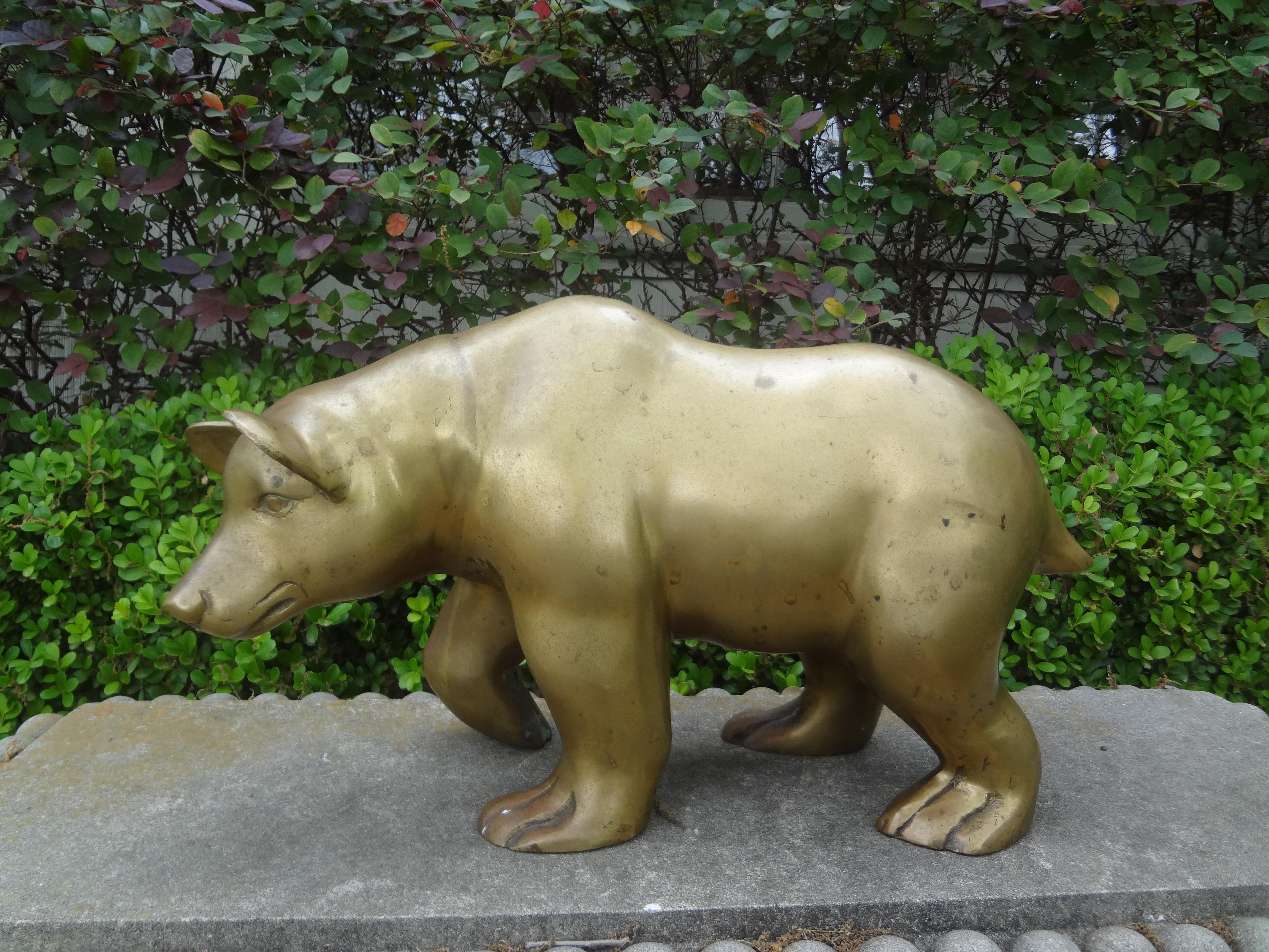 Large brass bear sculpture.
Our large Hollywood Regency brass bear is beautifully executed and would make a great coffee table or bookcase accessory.
Our vintage brass bear is a friendly bear!
Nice patina. Could be polished if desired.