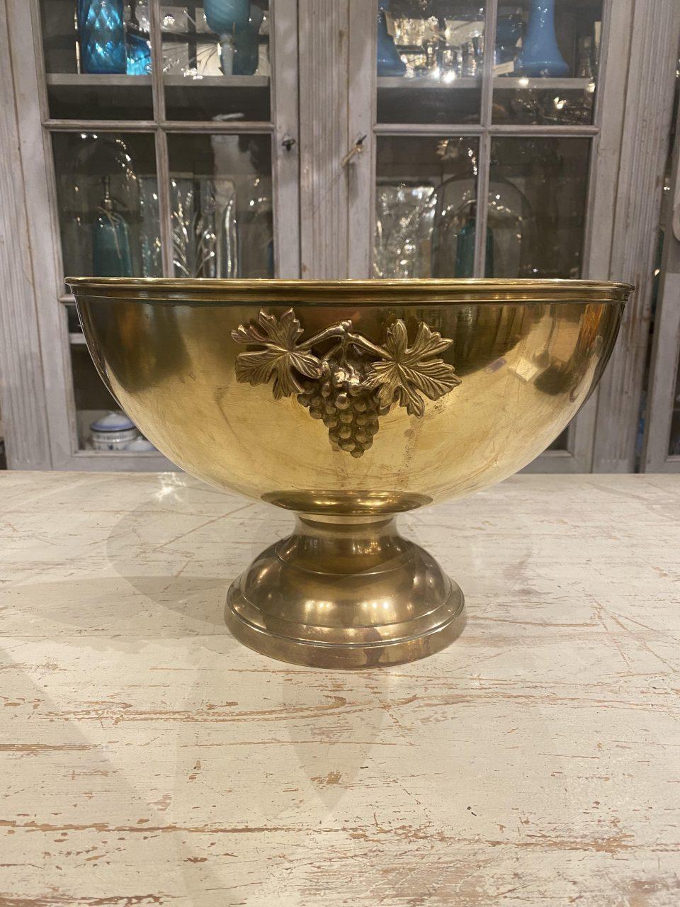 Wonderful French champagne cooler / bucket, beautifully raised on a base. Made of quality brass, and has space for 4-5 bottles in its round bowl. Beautifully decorated with ornamentation of vines and grapes on the side. Lovely patina.