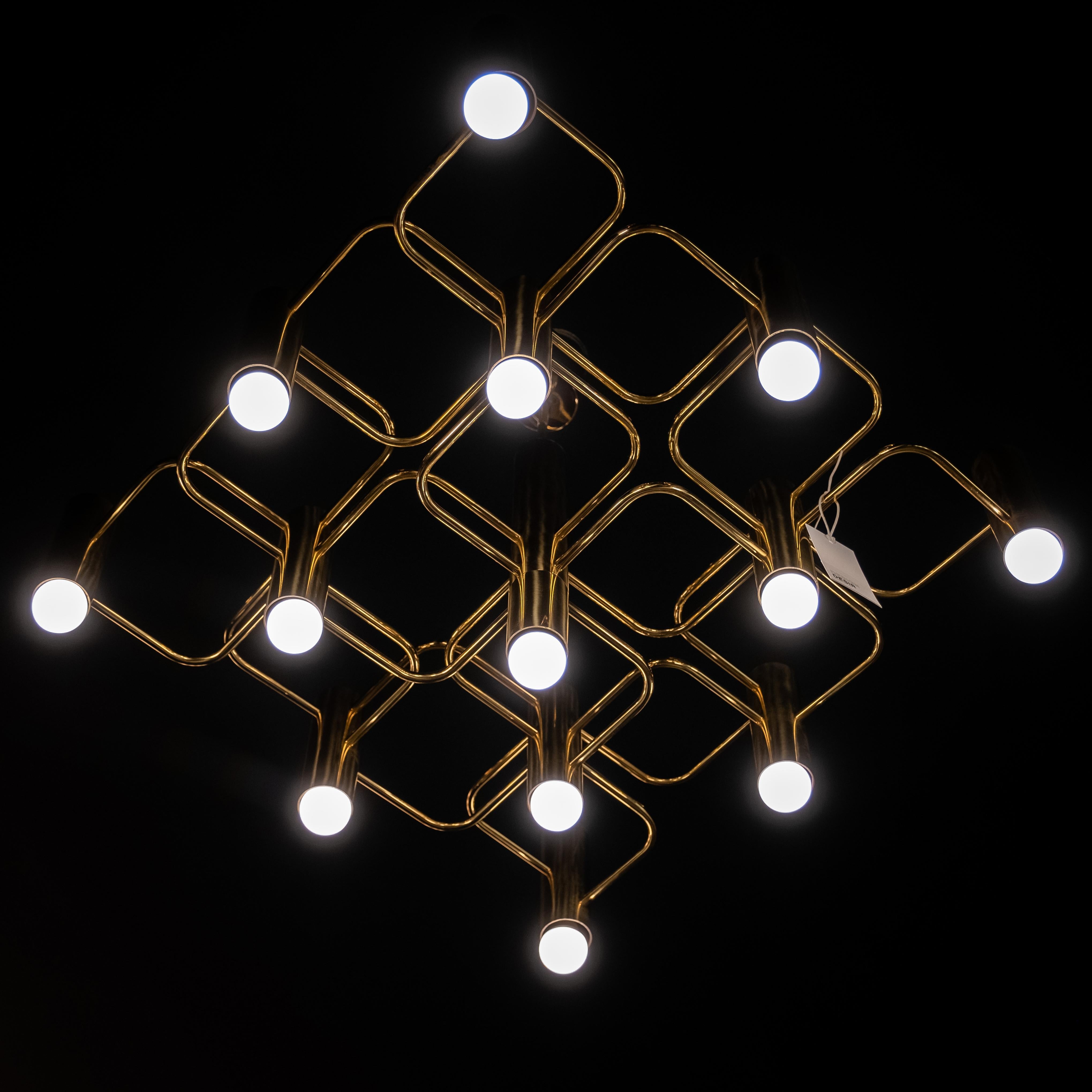 Wonderful large ceiling Lamp by Gaetano Sciolari for Belgian manufacturer S Boulanger in the 70s.

Umbued with timeless elegance this sculptural  brass chandelier with 13 light fixture captivates with sleek lines and throutful details.
It has a