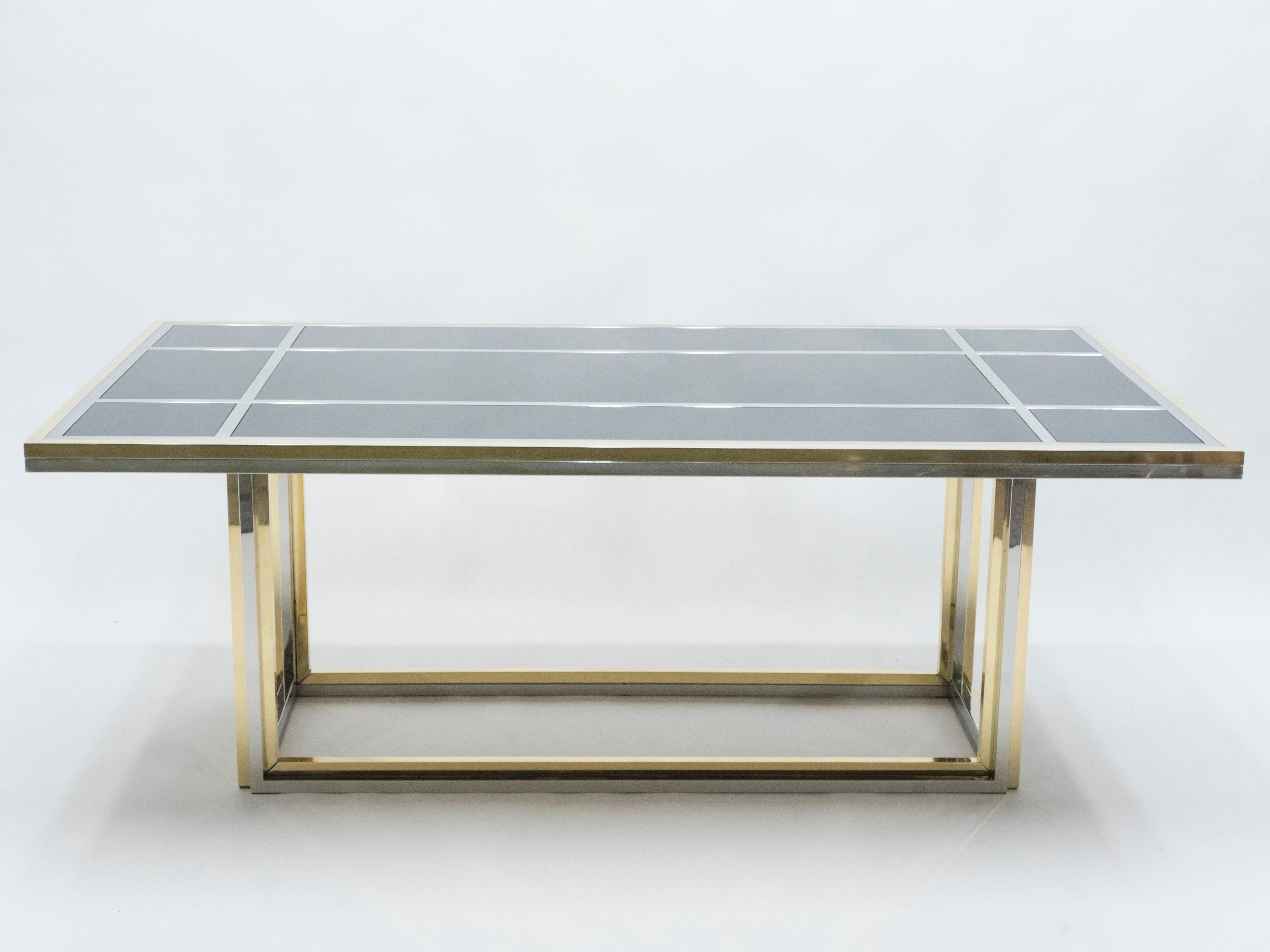 An intriguing piece of design, this large dining table deserves to be the focal point of your dining room. Symmetrical brass and chrome elements strike through a black opaline glass top, the result being an impressively sleek dining room
