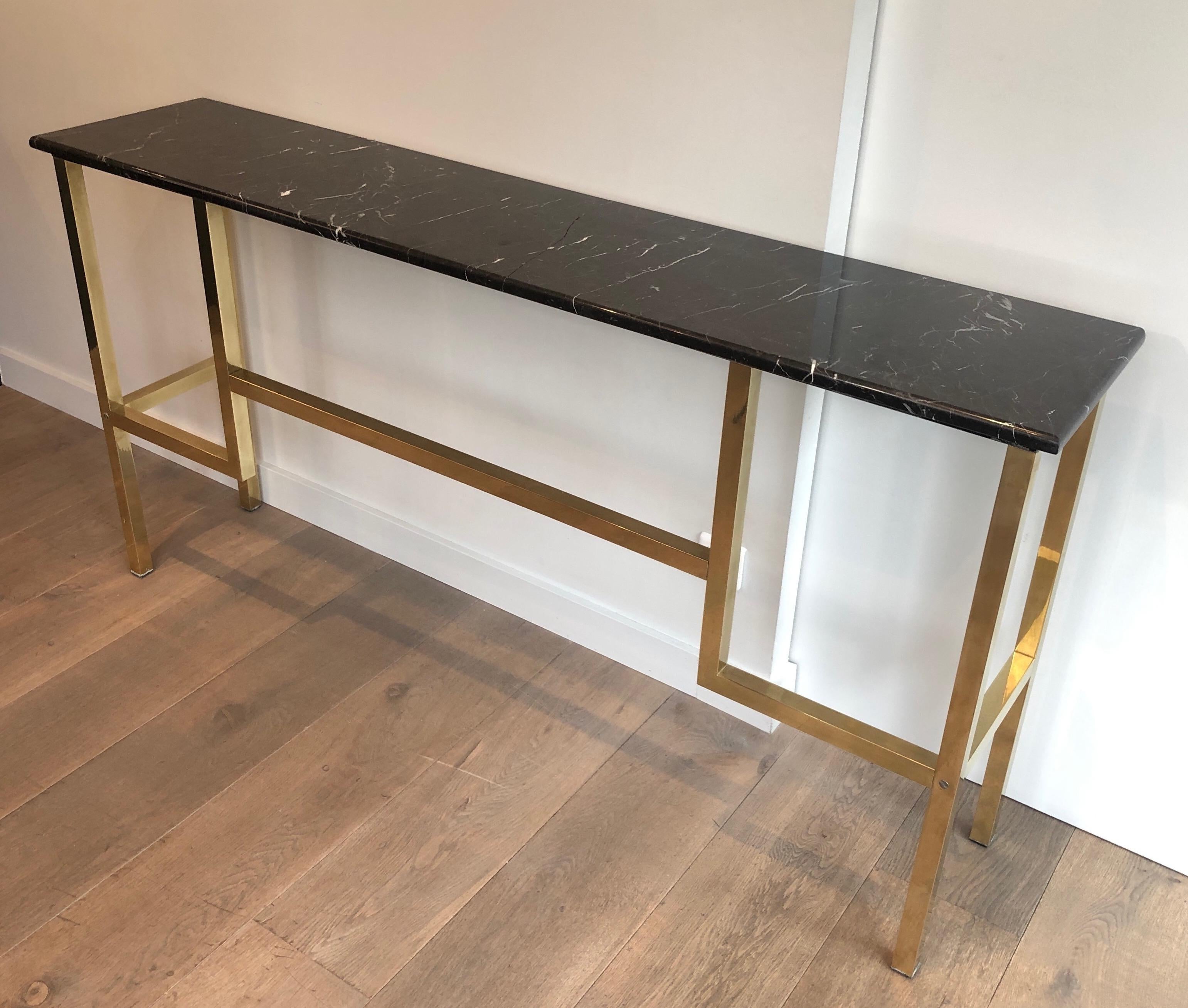 Large brass console table with black marble top. The model is very unique and rare and we didn't find any similar one. This is a French work, attributed to famous designer Guy Lefèvre for Maison Jansen. Circa 1970. The marble top has been restored.