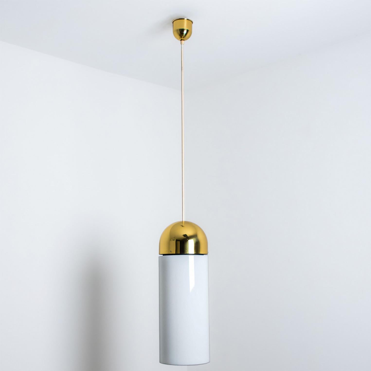 A wonderful round brass chandelier, circa 1970, made by Glashütte Limburg, Germany.
With thick hand-blown white glass with a brass top and a cylinder-like structure. Illuminates beautifully. Hig-end pieces form Germany.

Dimensions:
Diameter: 8.66