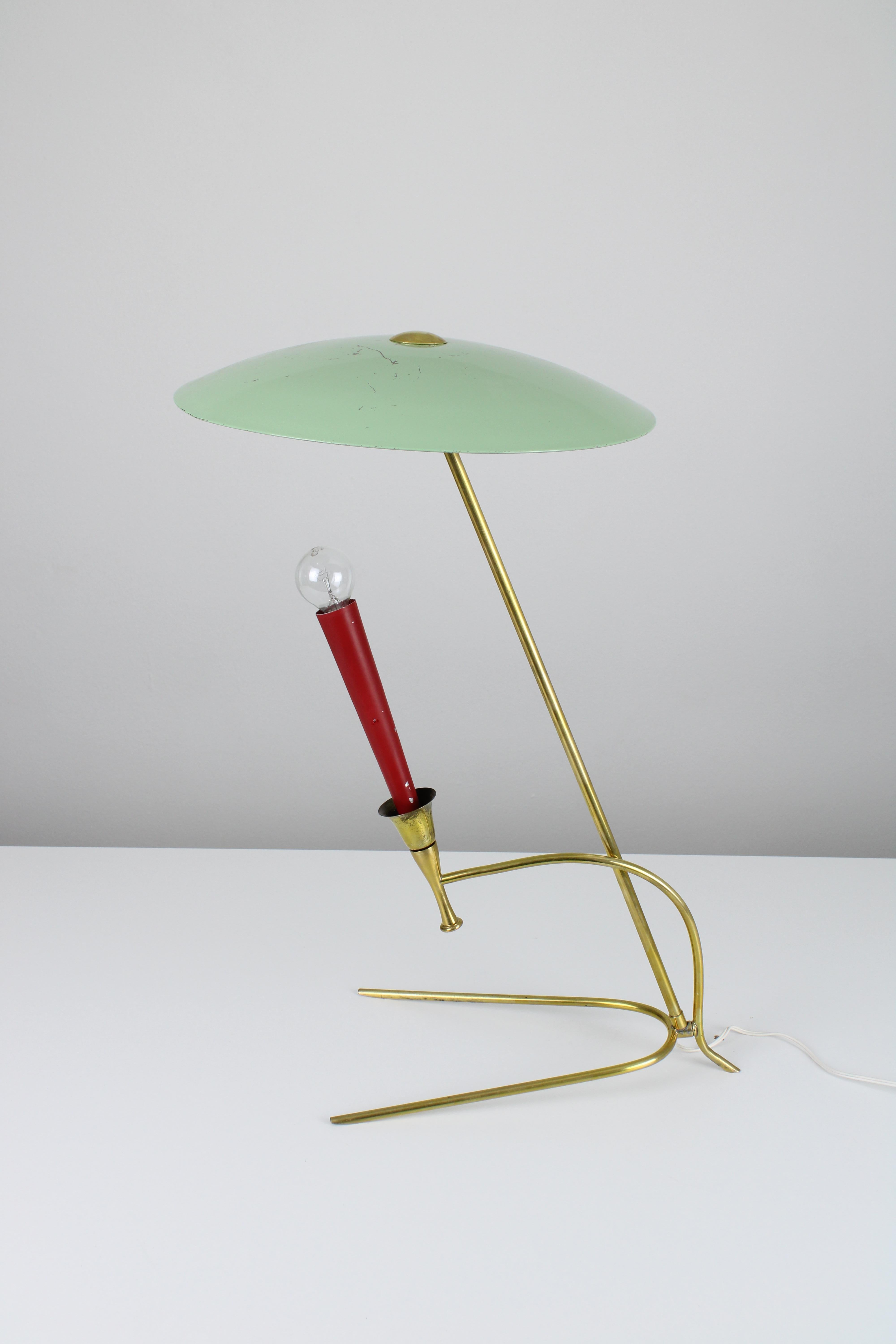 Brass desk lamp manufactured in France circa 1950s. The design of this lamp features a brass structure with smooth curves and patina. On this lamp you can find typical French colors from the 50s. Mint green and Bordeaux red were very popular at that