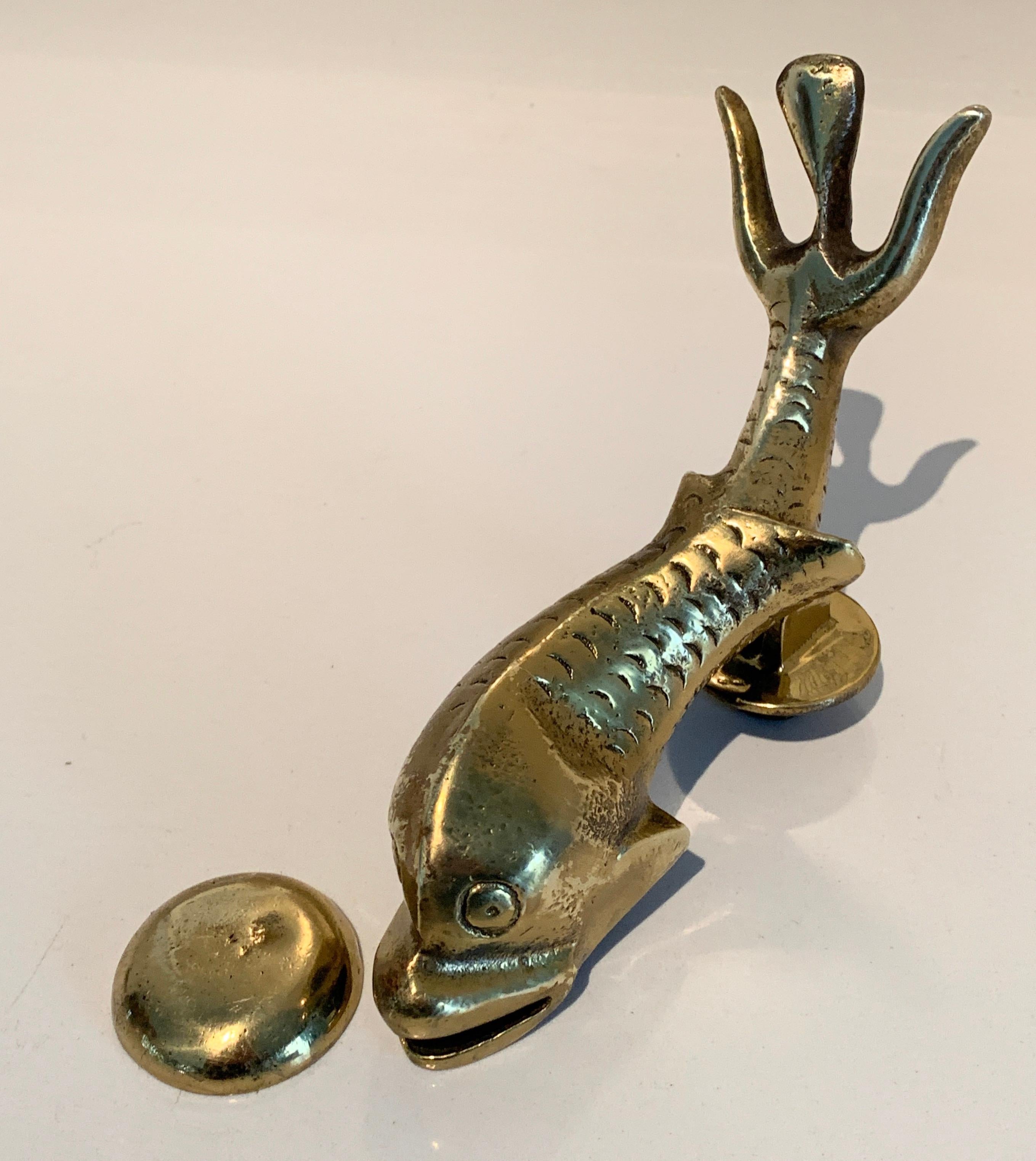 Large brass dolphin fish door knocker a wonderful curation fish with carved detailing, the piece has a round strike piece to knock with. A great midcentury piece, we have included Brass screws that may work with most doors.