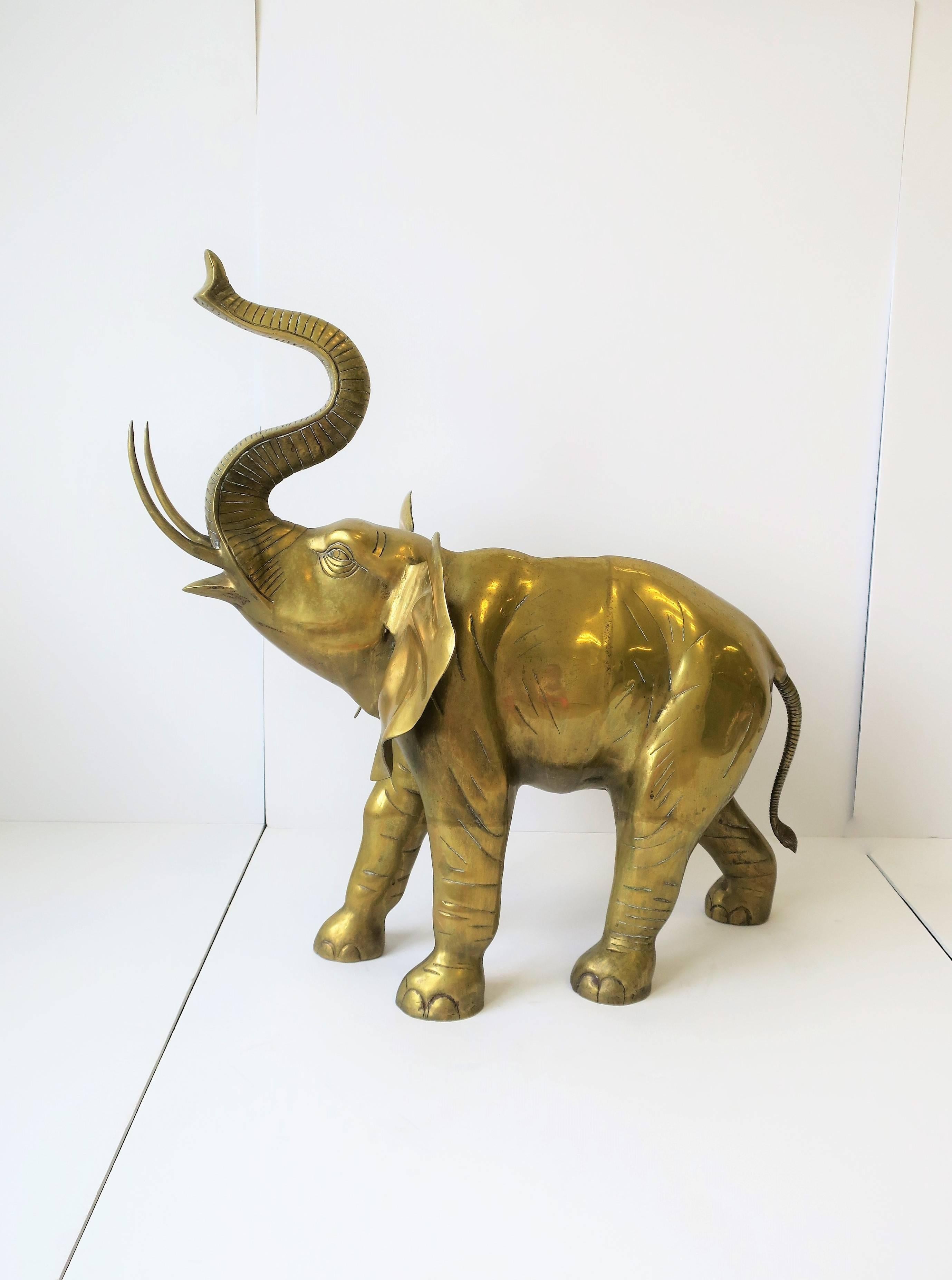 A substantial and relatively large brass elephant, circa 1970s, India. Image #12 (car key on R) and image #13 on top of coffee table, for scale. Beautiful details from trunk to tail. 

Elephant measures: 16.75