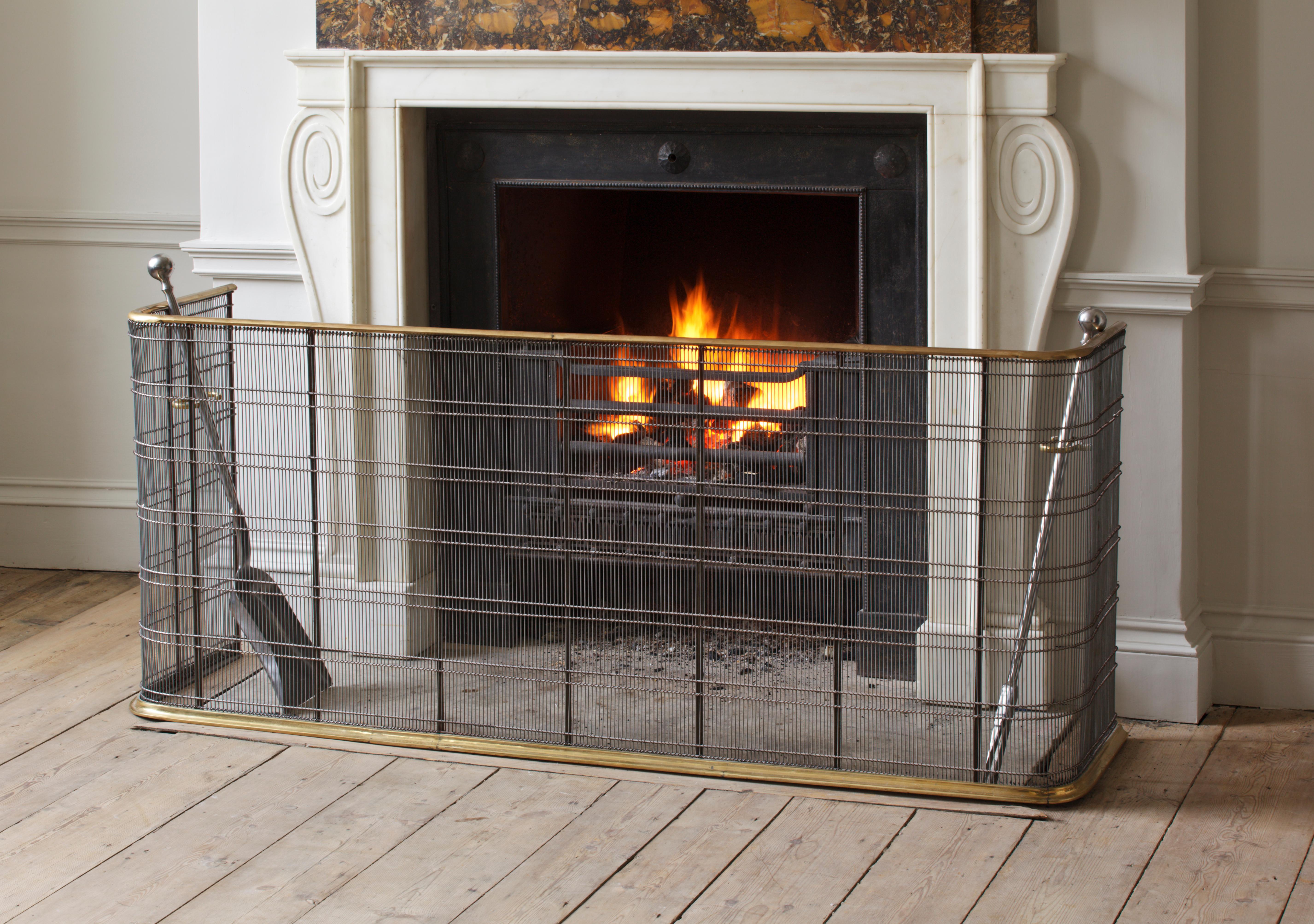 This faithful copy of an early 19th century fender, or nursery fire guard, provides ultimate protection combined with the elegance of moulded brass and finely worked mesh.
 
