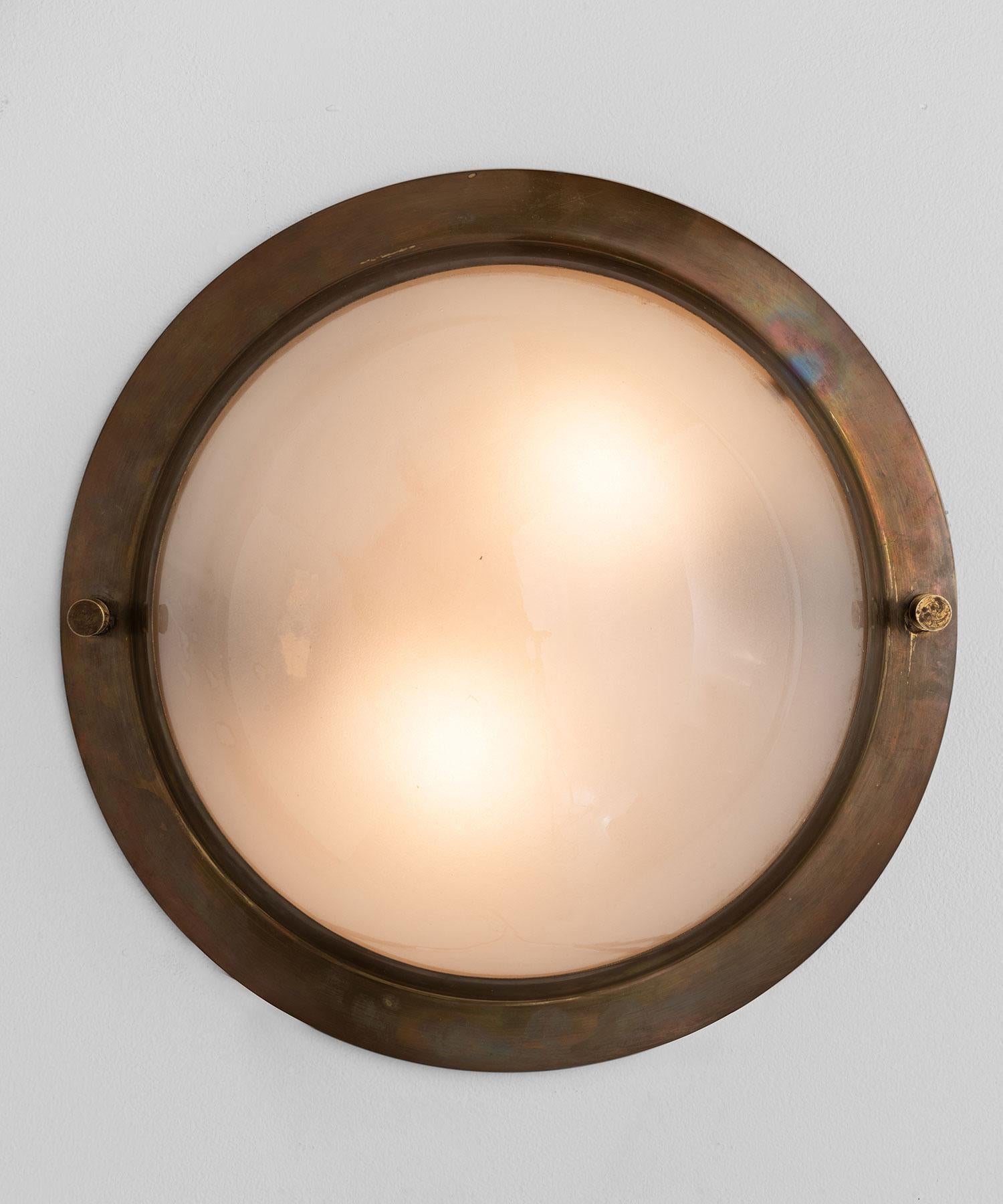 Large brass and frosted glass flush mount, Italy, circa 1950.

Thick brass surround with spherical frosted glass shade.

  