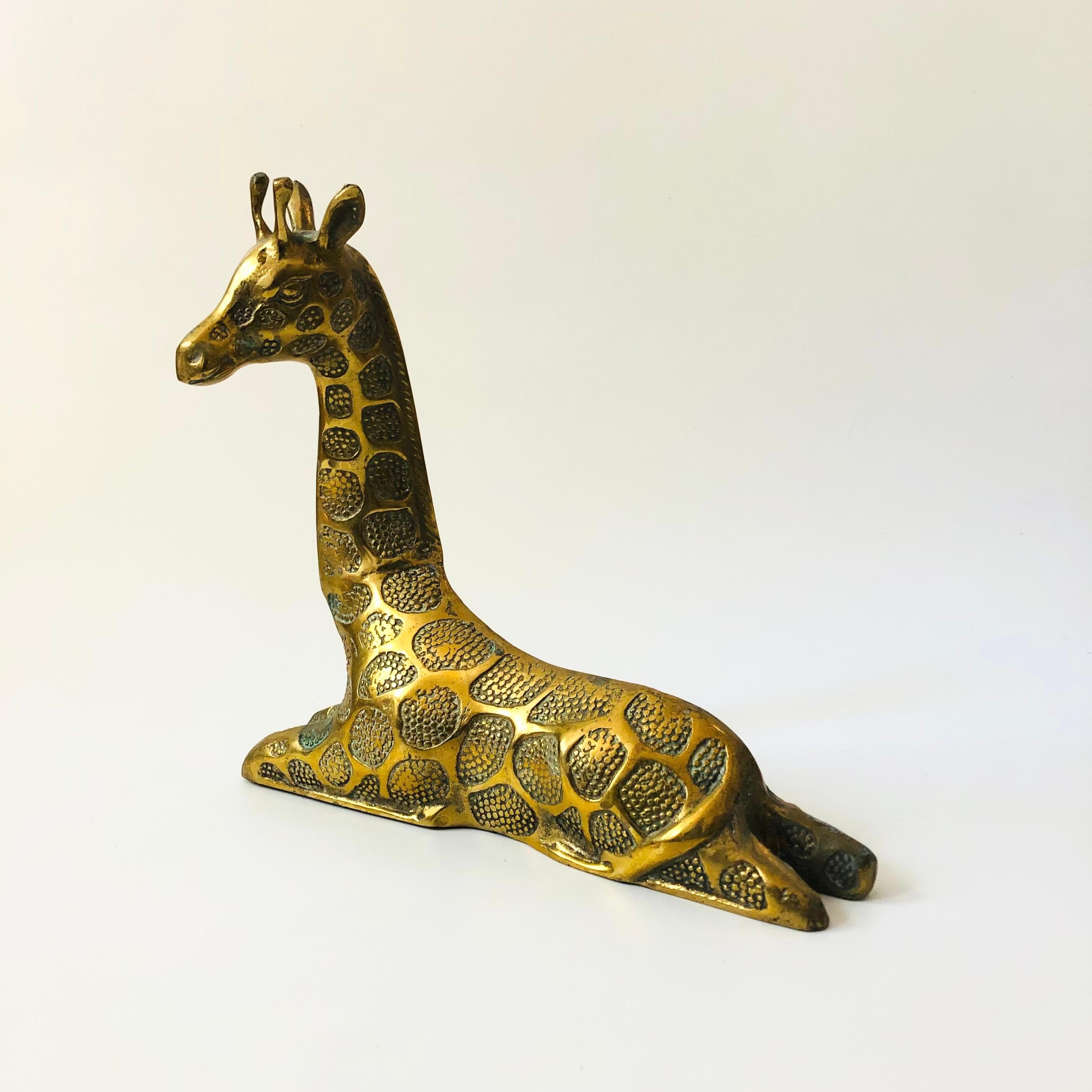 A large vintage brass giraffe in a laying down position. Beautiful realistic detailing formed into the brass, a unique large statement piece. Made in Korea.

