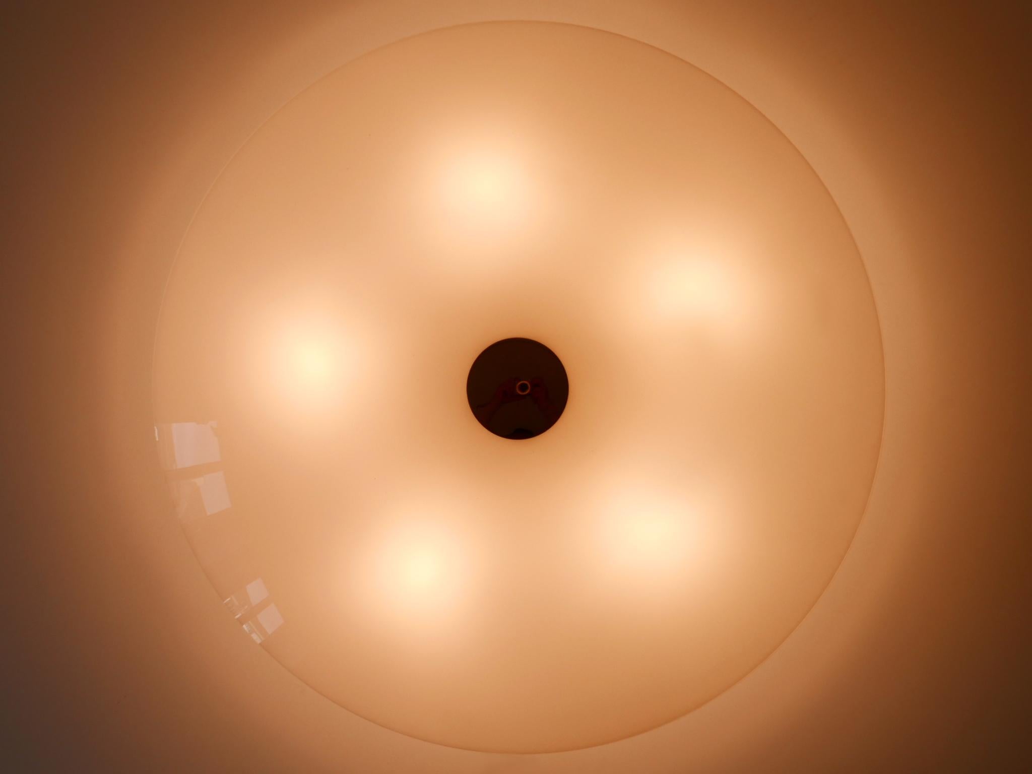 Large, elegant and minimalist flush mount / sconce. Designed & manufactured by Florian Schulz, Germany, 1980s.

Executed in polished brass and opaline glass, the fixture is executed with 5 x E27 / E26 Edison screw fit bulb holders, is wired and in