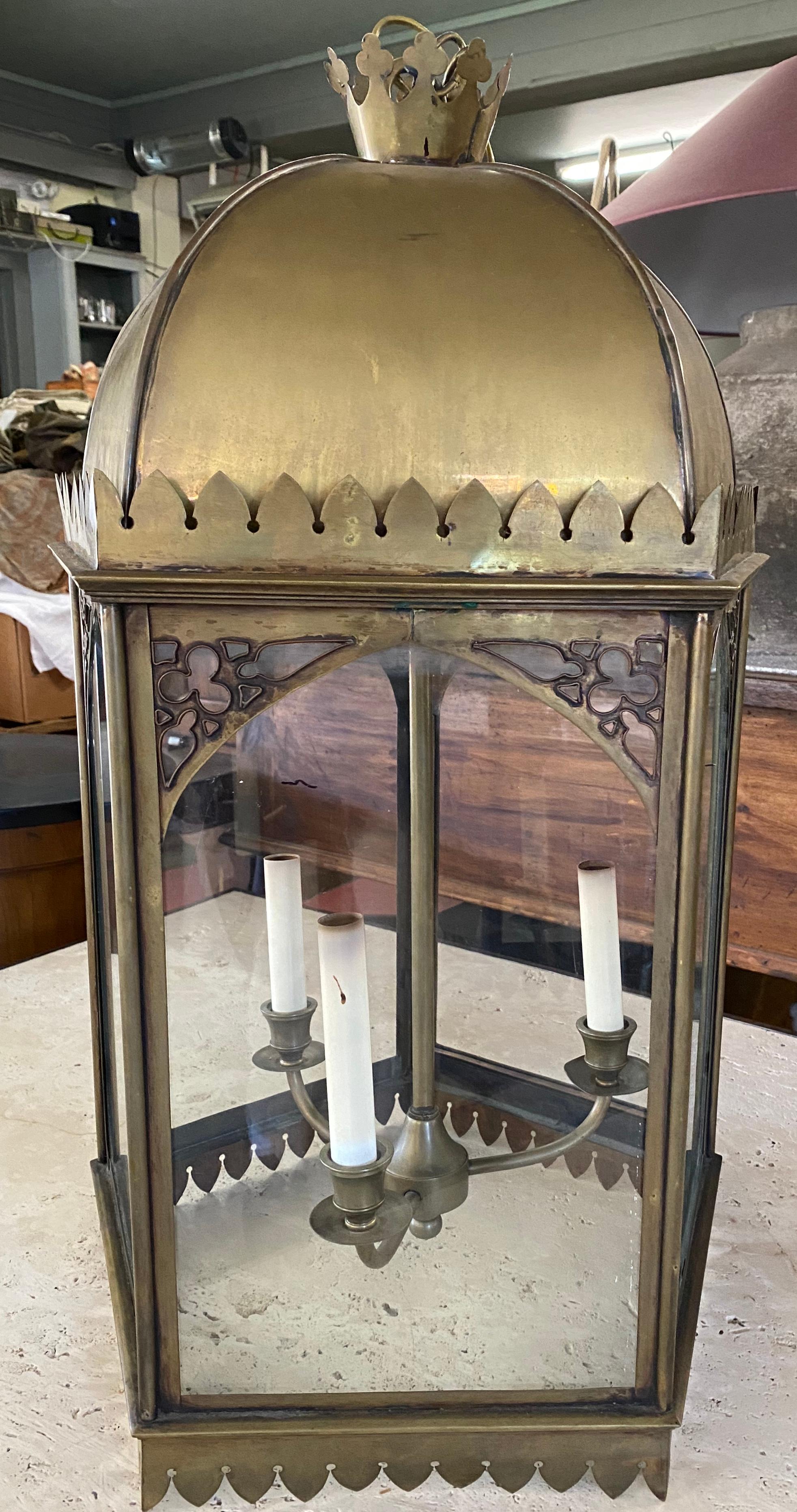 Large and impressive Gothic style 5 sided brass and glass encased hanging lantern electrified with 3-light. Wonderful aged brass patina.
