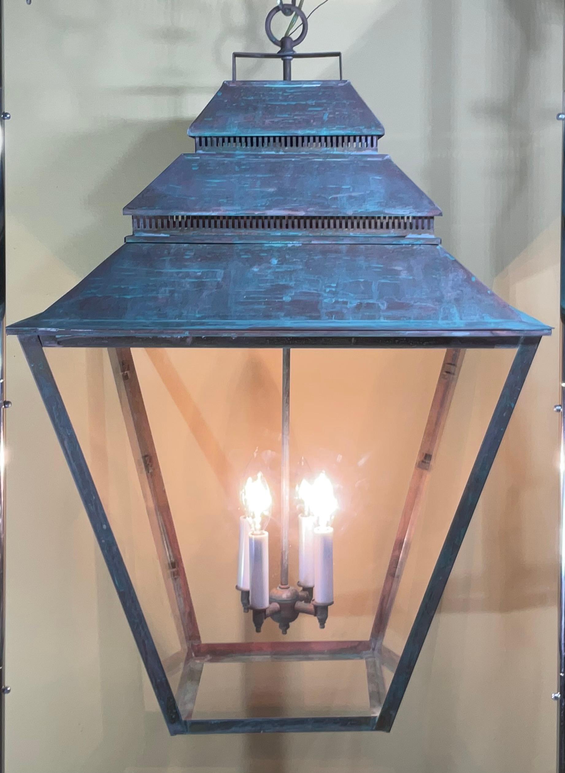 

This is a statement piece! This magnificent brass  hanging lantern commands attention with its substantial size and rich patina. Crafted with meticulous detail, it exudes timeless elegance and adds a touch of old-world charm to any space.  brass