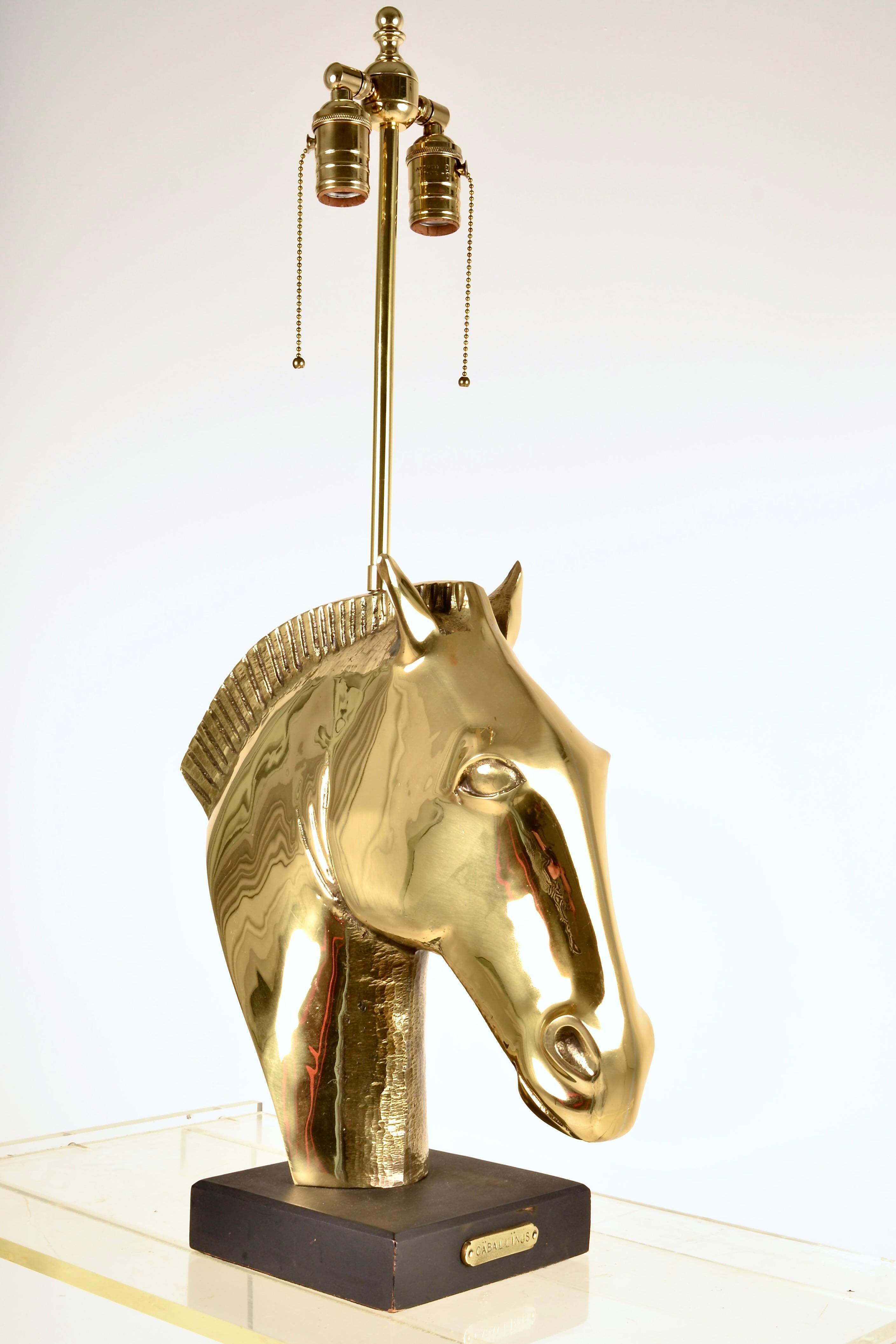 Superb quality lamp featuring a heavy cast brass sculpture of a Roman-style horse head. Brass plaque attached to wooden base is engraved with the word CABALLINUS, horse in latin. Very fine lamp conversion, also in brass with new wiring. The brass