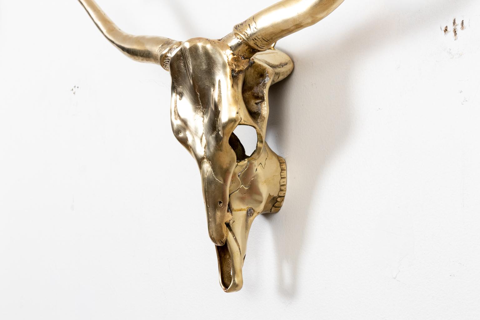Circa mid-20th century Hollywood Regency style decorative brass longhorn skull wall sculpture in a hand polished finish. Made in Korea. Please note of wear consistent with age. Good overall condition.