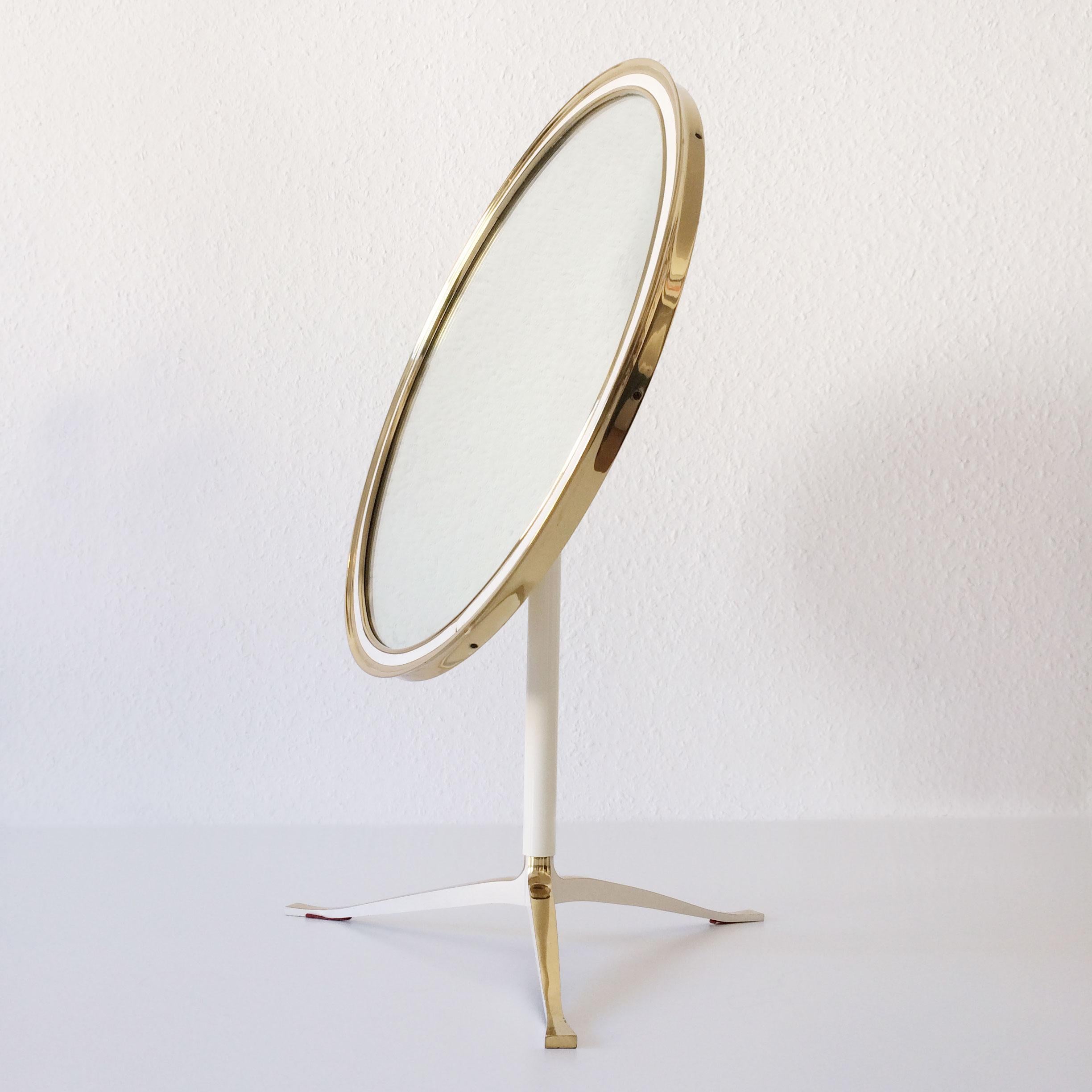 Extremely rare and decorative Mid-Century Modern table mirror with brass frame. Manufactured by Vereinigte Werkstätten München, Germany in 1960s.

This large make-up mirror is executed in solid brass and can be adjusted easily in wished position.