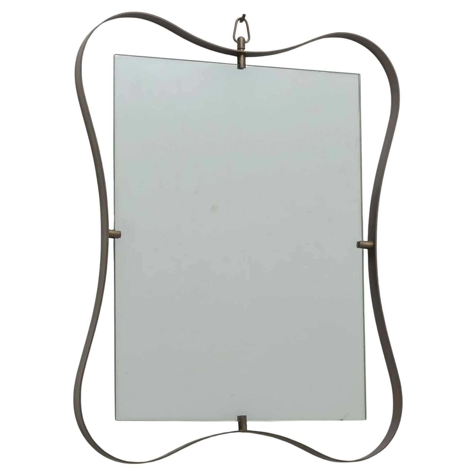 Large Brass Mirror by Fontana Arte, circa 1950

The whimsical brass frame forms a ribbon design fixing a rectangular mirror plate at four points.

A rare piece and the largest of three sizes produced by Fontana Arte.

Published: 'Lastre di vetro e