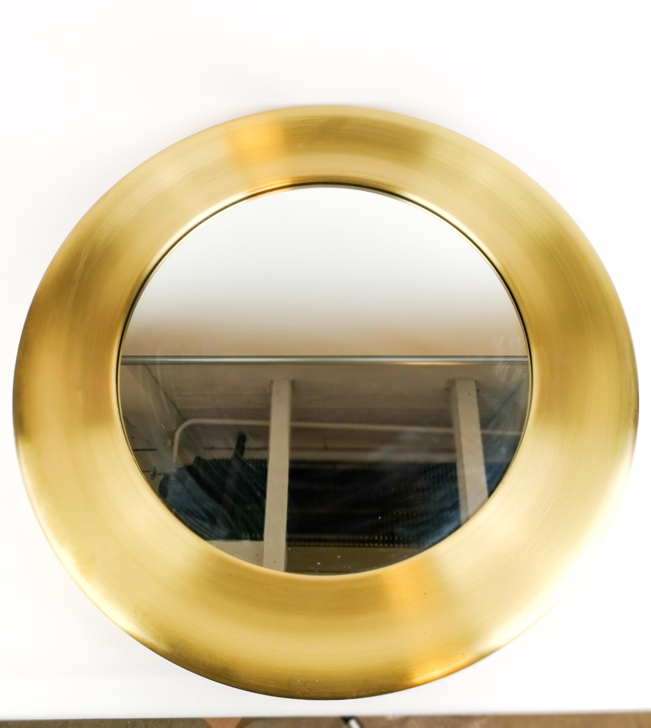 Round glass mirror from Glasmäster with brass frame. It was made in Sweden for Glasmäster (glass master) in Markaryd and is often connected to Hans Agne Jakobsons Work in Markaryd.

This mirror is in good condition, one small bump and some stains