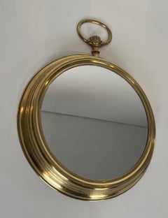 Large brass mirror showing a pocket watch. French work. Circa 1970