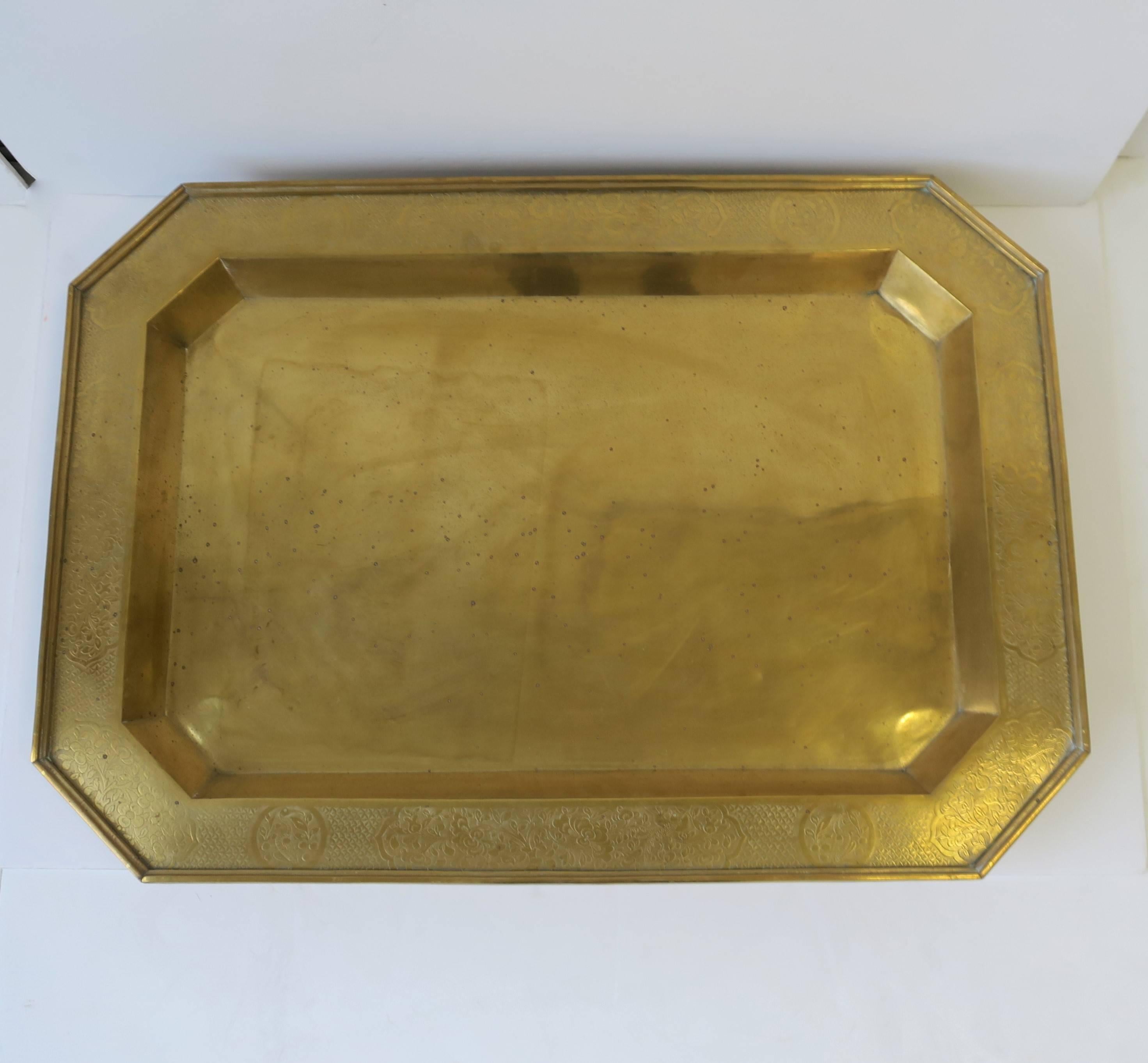 A beautiful, large, and substantial vintage brass octagonal serving tray. Tray has decorated edge featuring birds and botanicals.

Tray measures: 25.75 in. W x 18.25 in. D x 3 in. H

