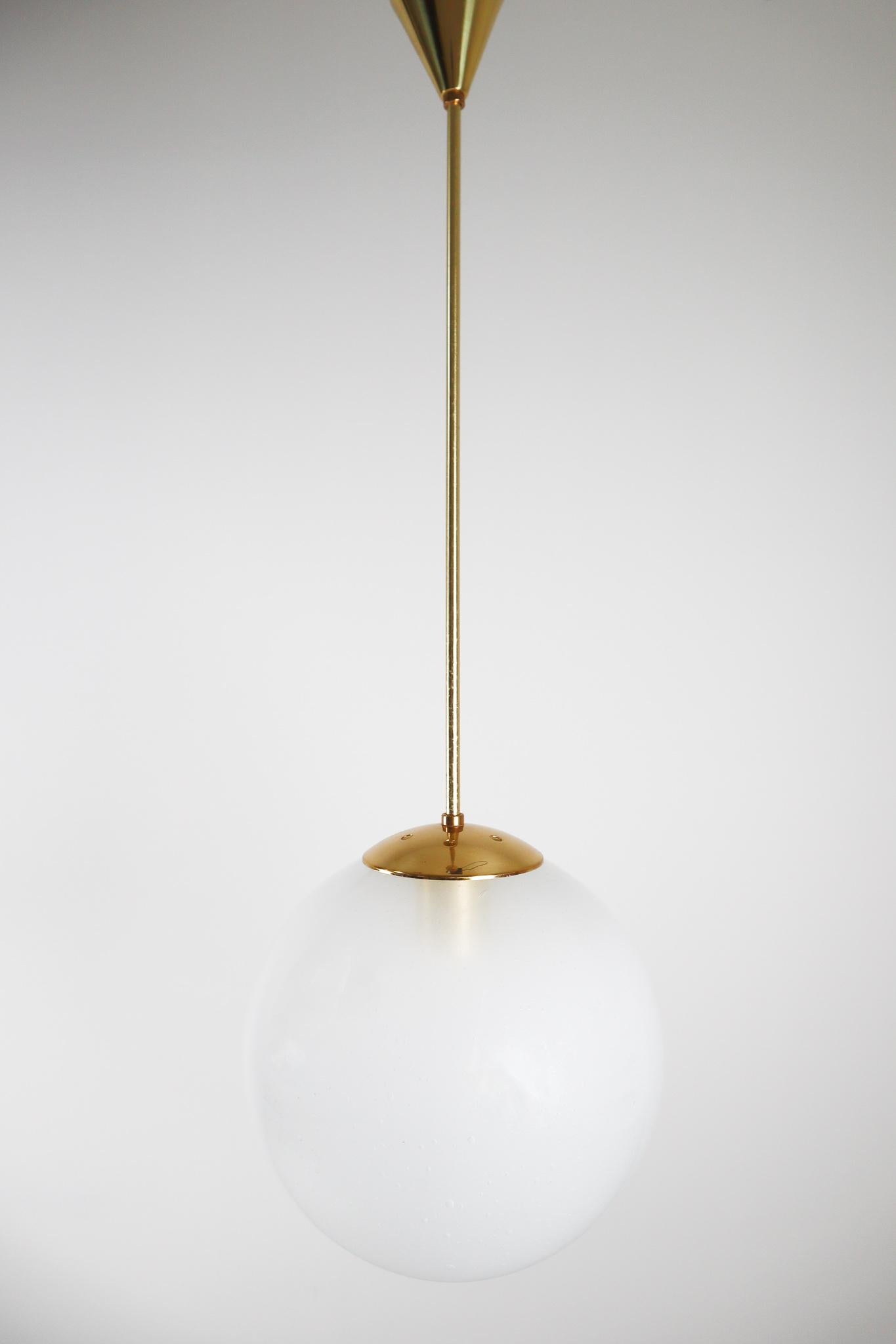 Large elegant brass pendant by designer and manufacturer Preciosa Kamenický Šenov and produced in Czech Republic the early 1970s. Beautiful work with a pearl hand blown globe hanging by a brass rod. This pendant will create an absolute stunning