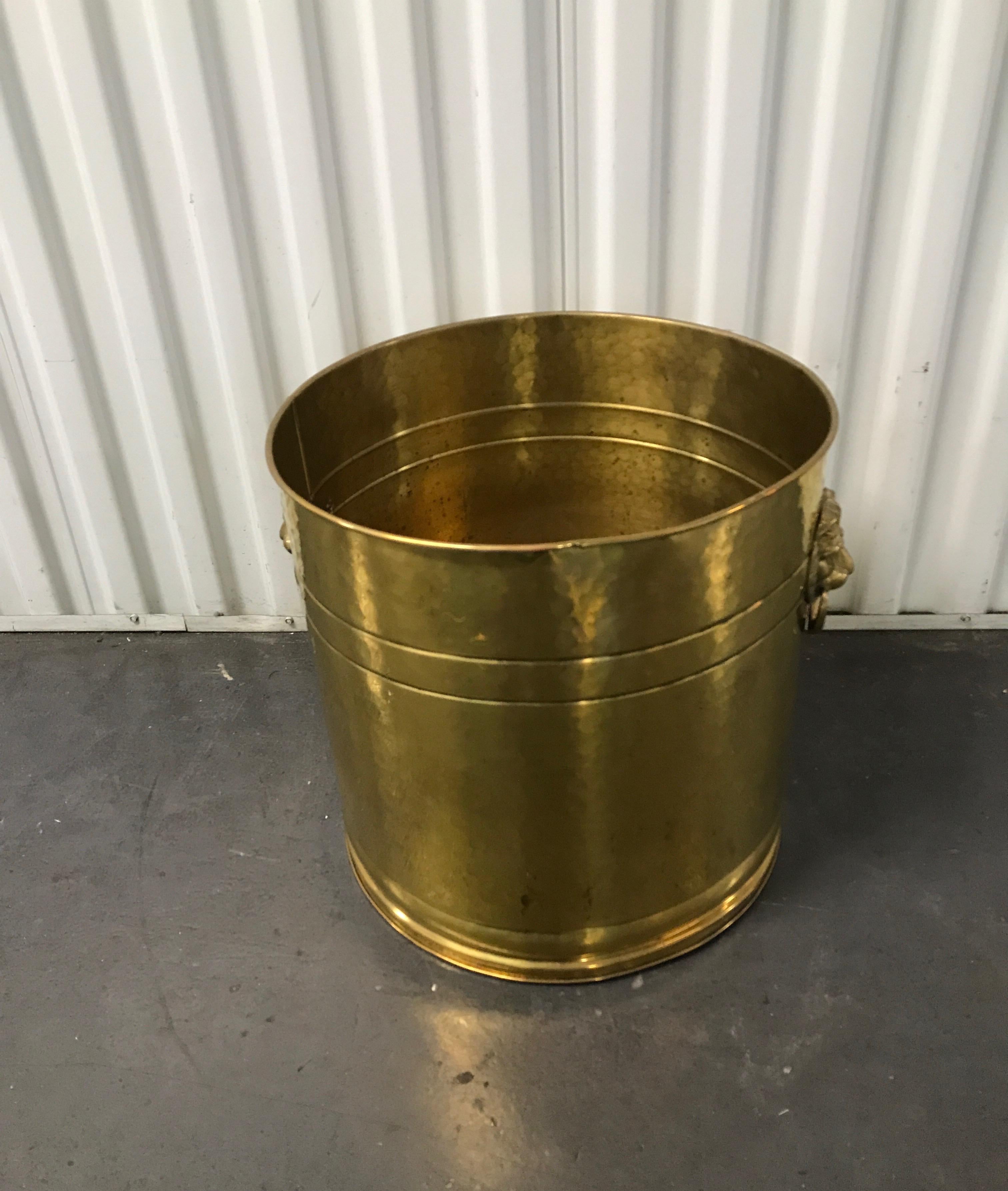 Vintage large scale brass planter with lion heads and rings on each side.