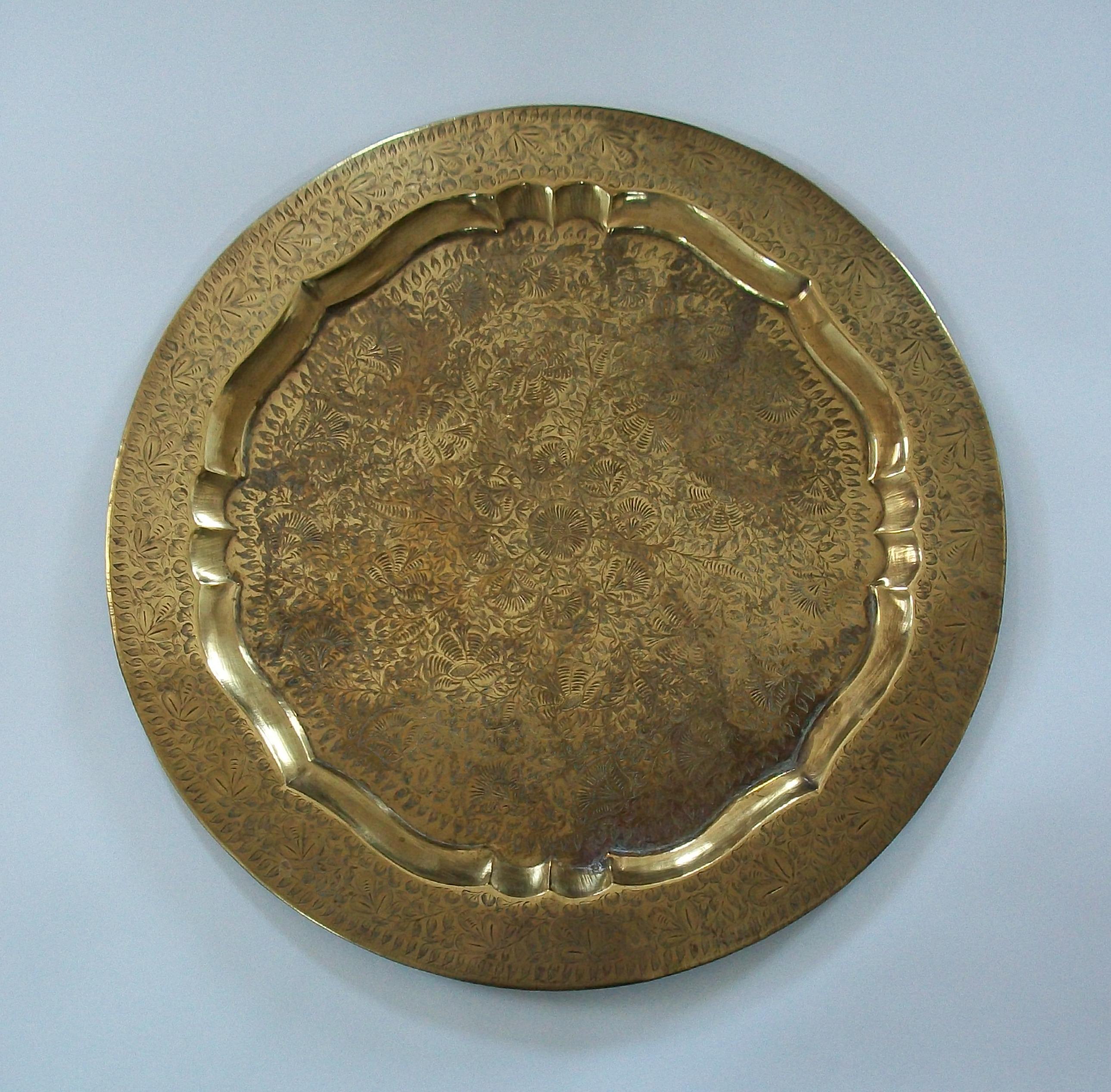 Large vintage South Asian solid brass serving tray - high quality with a warm aged patina - featuring a hand etched floral and leaf pattern throughout - raised border and rim - rolled edge - unsigned - India - circa 1980's.

Excellent vintage