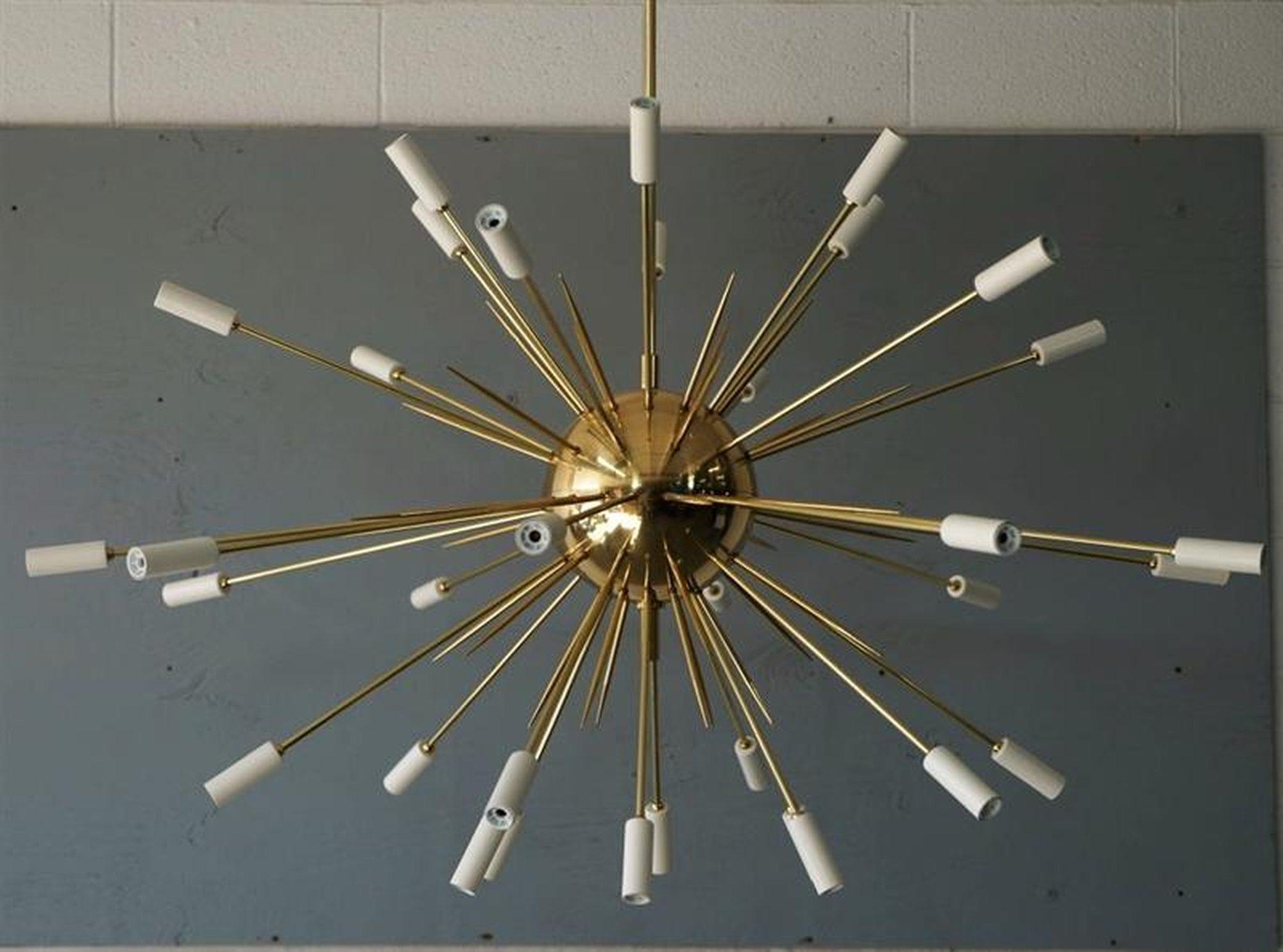Large scale Italian light fixture reminiscent of an exploding star with white tips. Brass rods--both lit (34 candelabra bulbs) and speared--shoot out of a brass core. High-quality, hand made piece by Fedele Papagni Milano.
Wired for the US