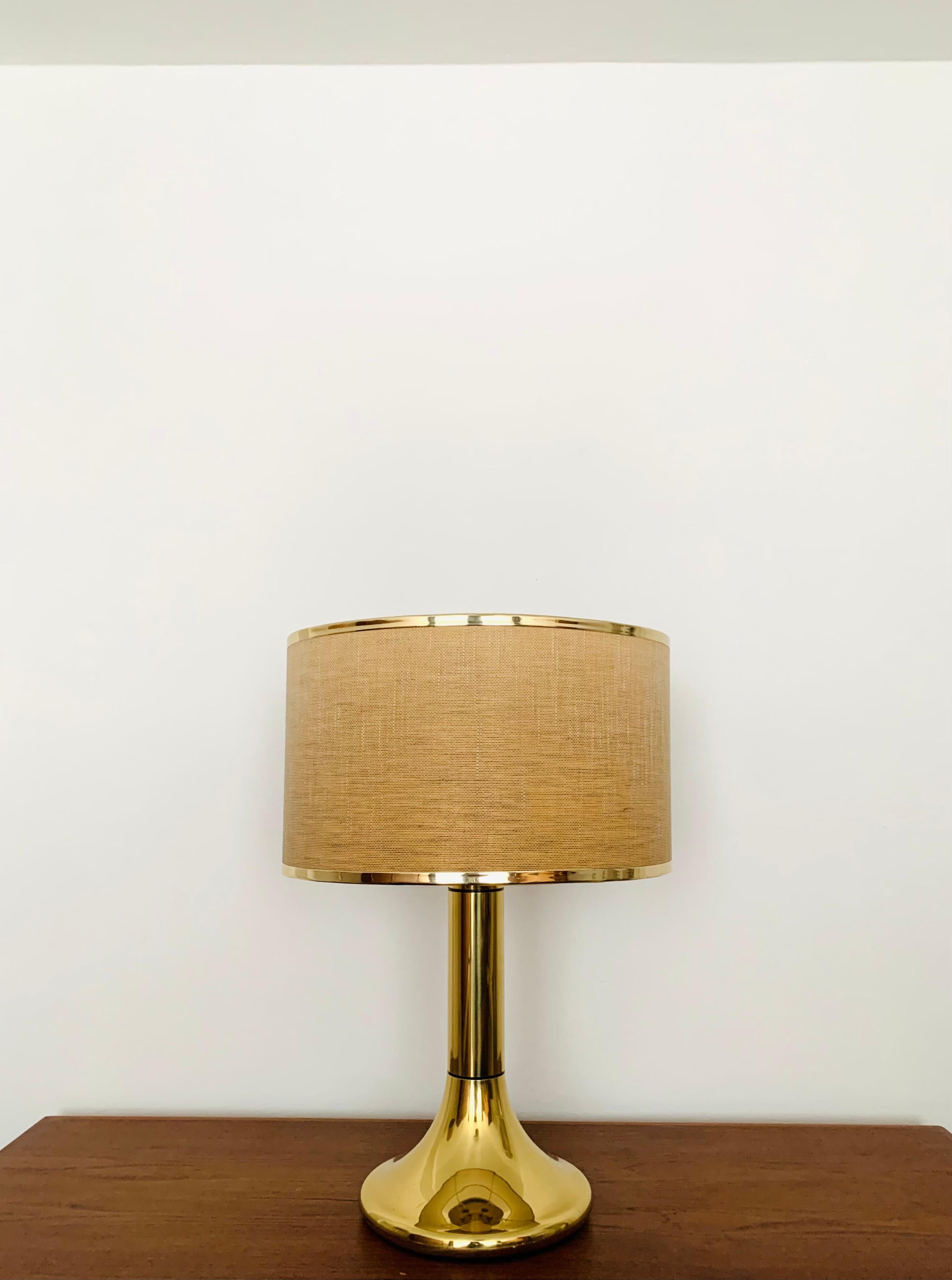 Very large brass table lamp from the 1960s.
The design and the special lampshade create a very elegant and pleasant light.
The lamp creates a very cozy atmosphere and is very high quality.

Condition:

Very good vintage condition with slight signs