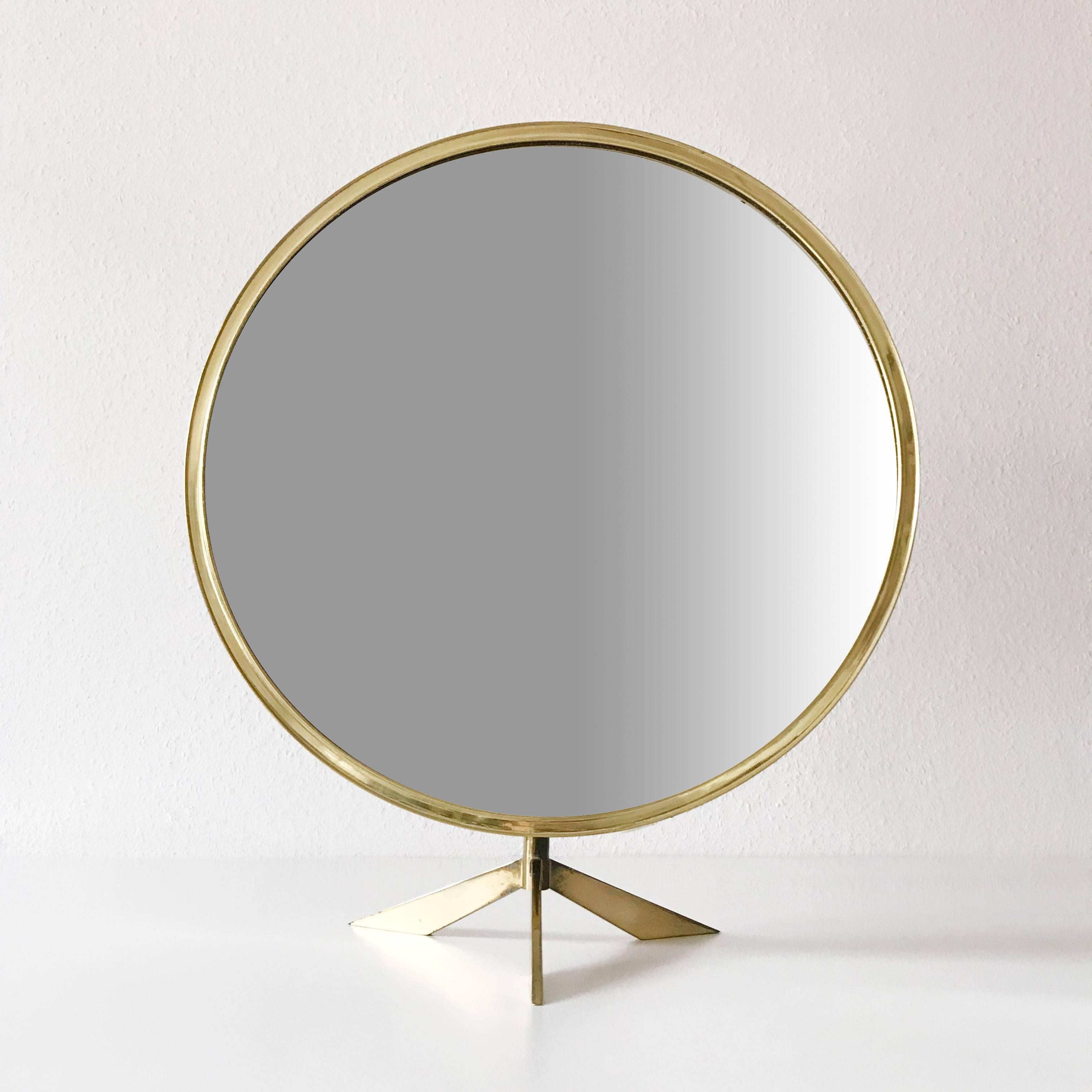 Exceptional Mid-Century Modern table mirror with brass frame. Manufactured by Vereinigte Werkstätten, Germany in 1960s.

This large make-up mirror is executed in solid brass and can be adjusted easily in wished position. 

Condition:
Good  original