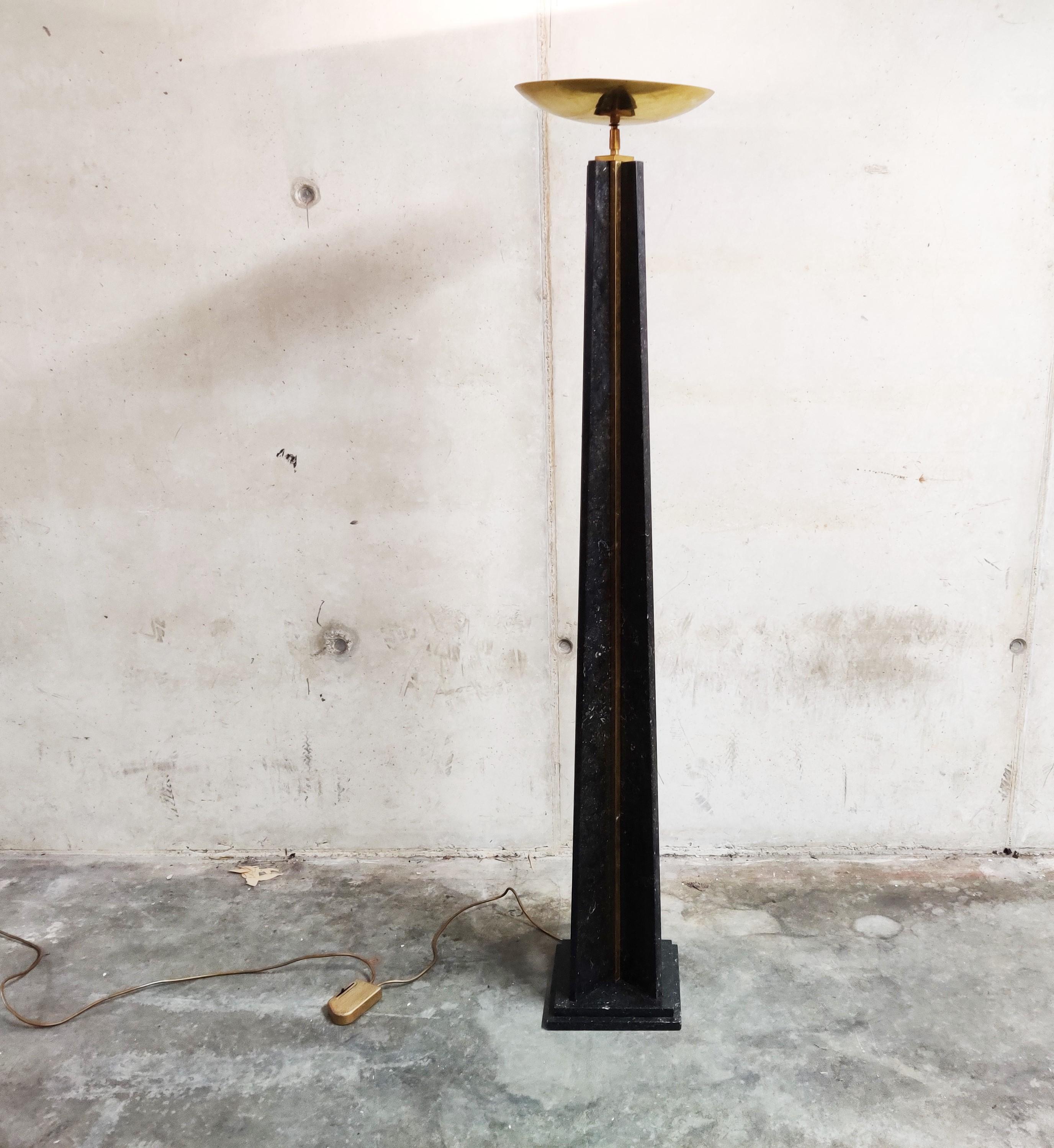 Large conical 'torchiere' floor lamp made from brass and black lacquered metal.

This uplighter floor lamp is dimmable.

Very small damage on the underside of the brass shade, barely visible and patina on the base.

The lacquer is in very good