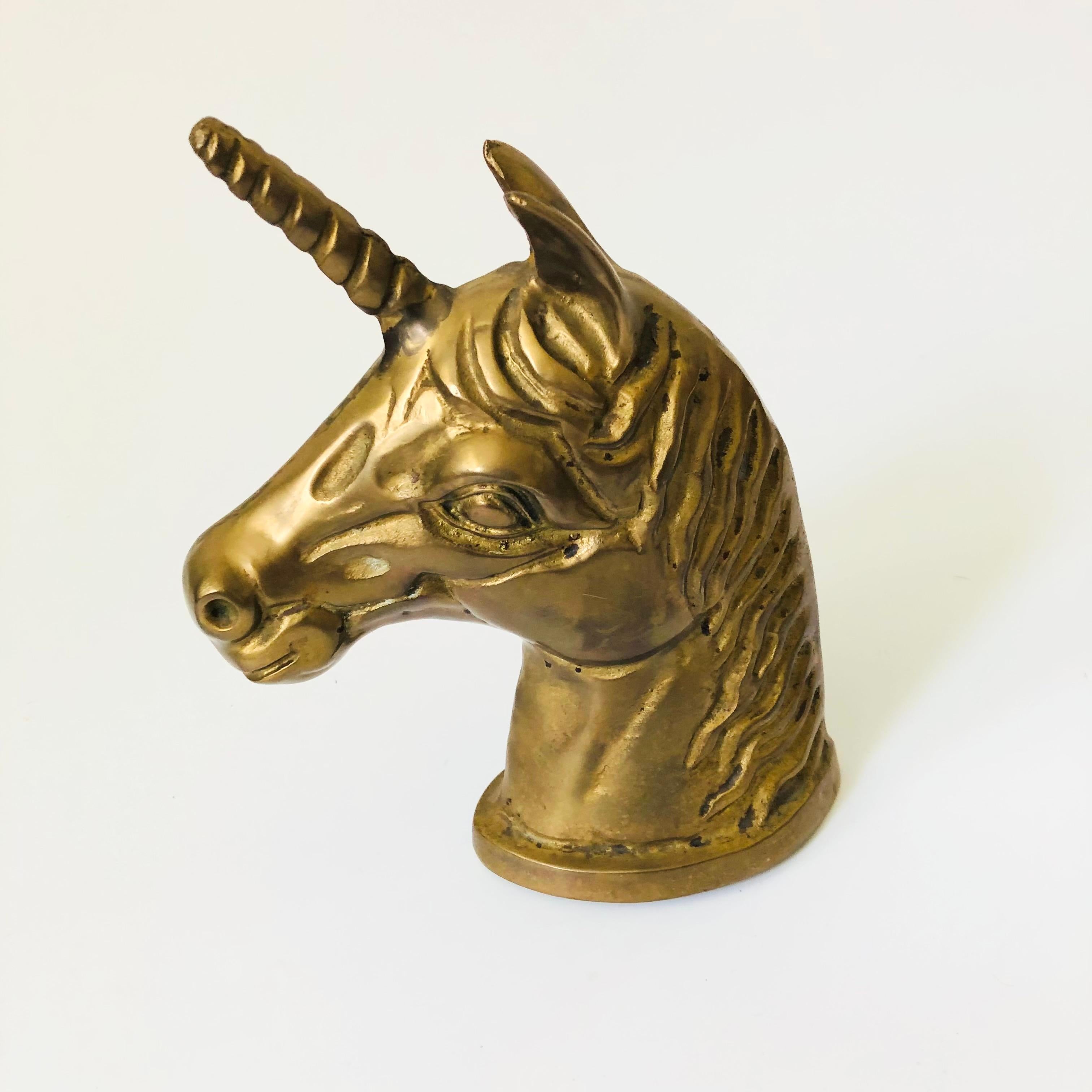A large vintage brass unicorn head.

