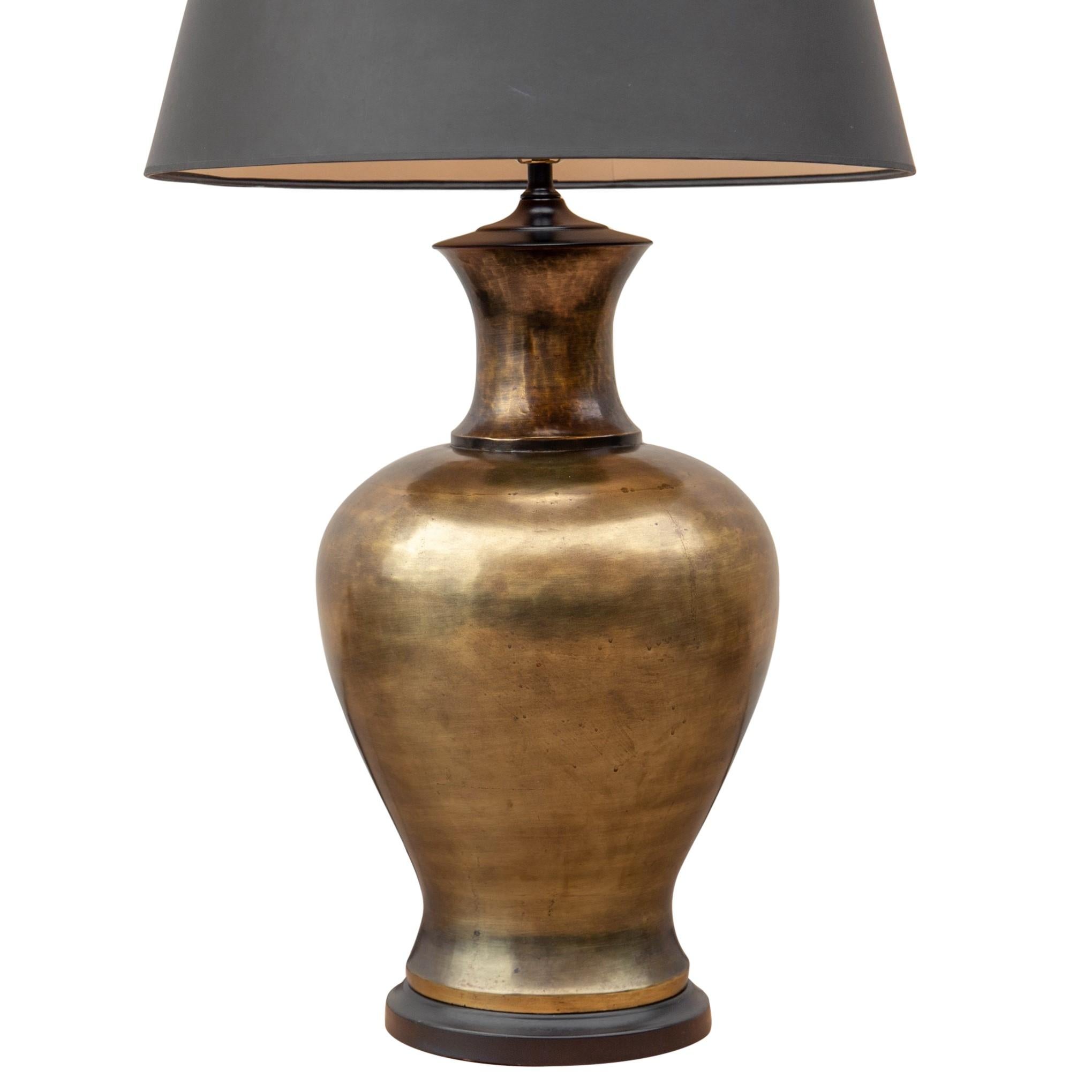 Large-scale solid brass urn-form lamp with black shade by Tyndale, a division of Frederick Cooper, circa 1960s. Original black Empire shade and black painted brass ball finial. The brass urn sits on a painted black brass base and measures 13