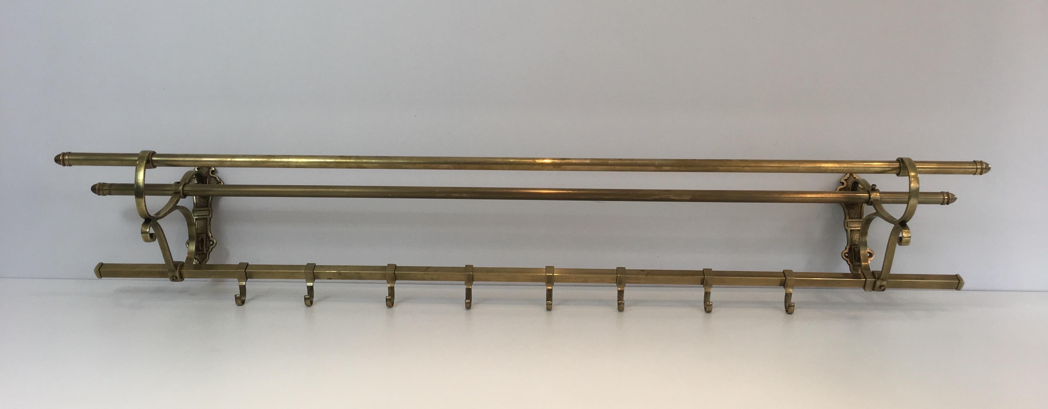 This large wall coat hanger and hat holder is all made of brass. This is a French work, circa 1900.