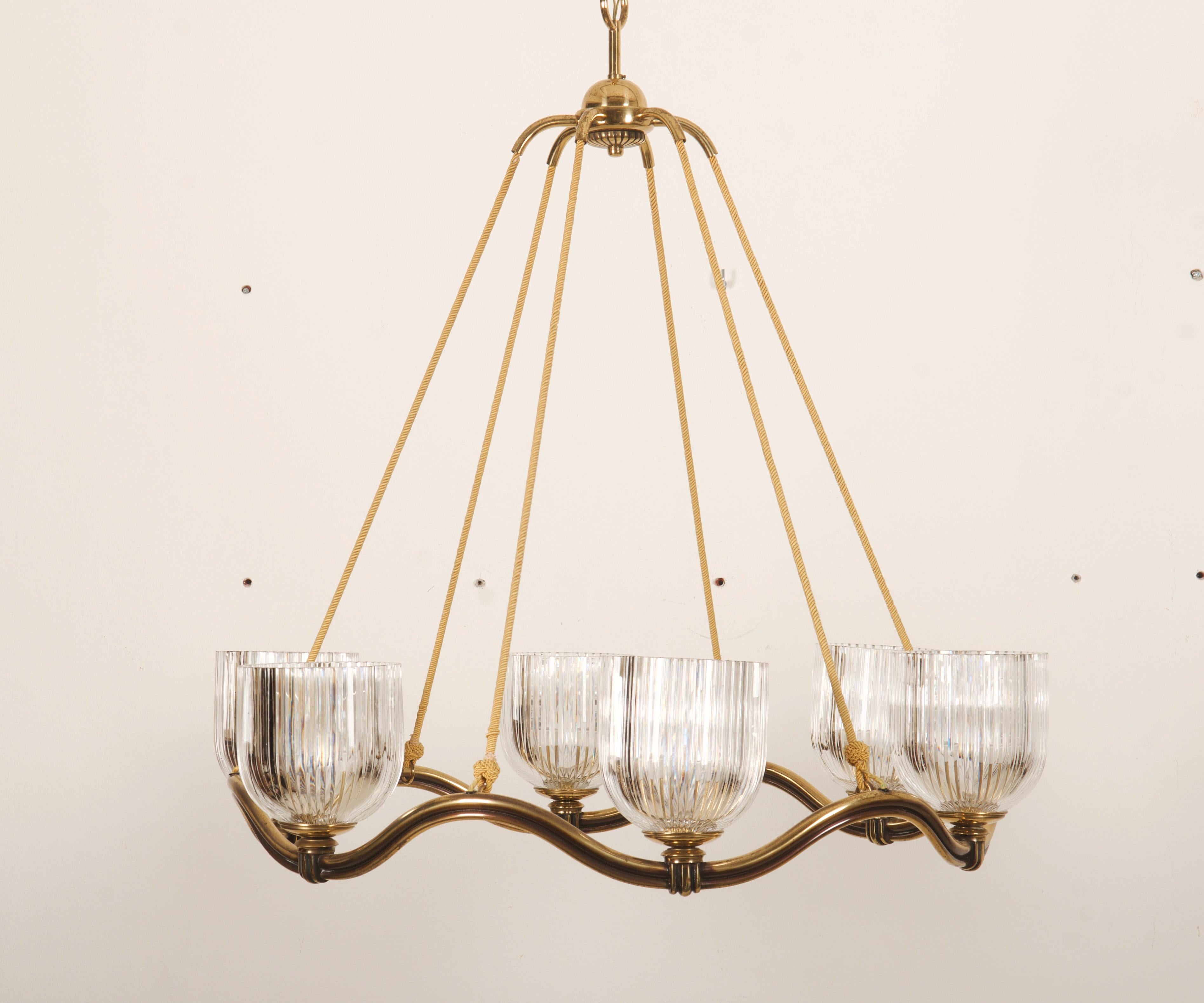 Brass wave-ring form fitted with six E27 sockets and hand blown and hand grinded crystal glass shades originally desigend by Otto Prutscher for Lobmeyr in the 1930s. The chandelier was designed in the 1930s by Hugo Gorge but this one was made in the