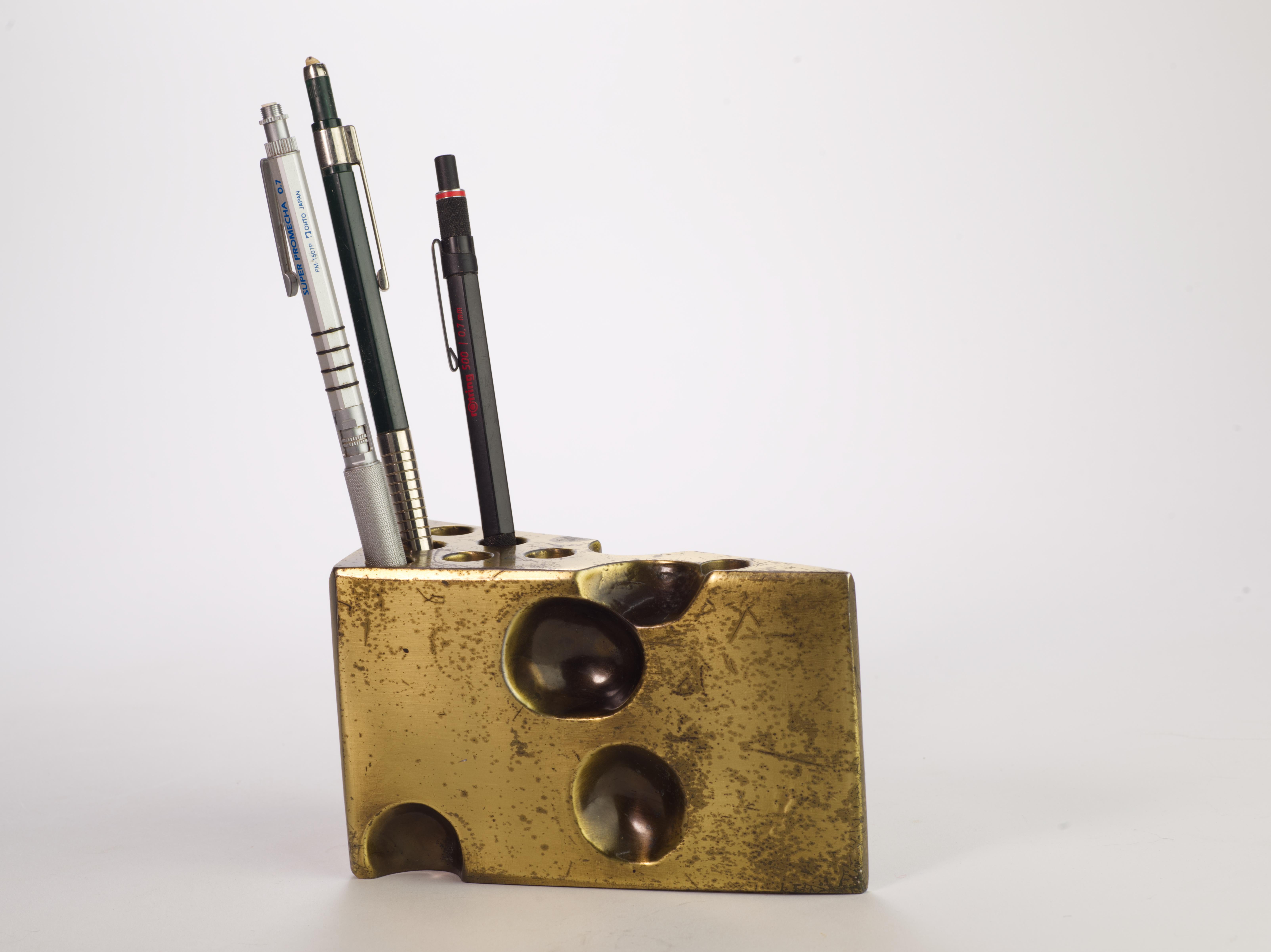 Large and heavy brass wedge of Swiss cheese is a functional art object that can be used as a paperweight or as a pen and pencil holder, or just as a decorative accessory. Beautiful, age-appropriate patina on brass adds to the vintage charm of the