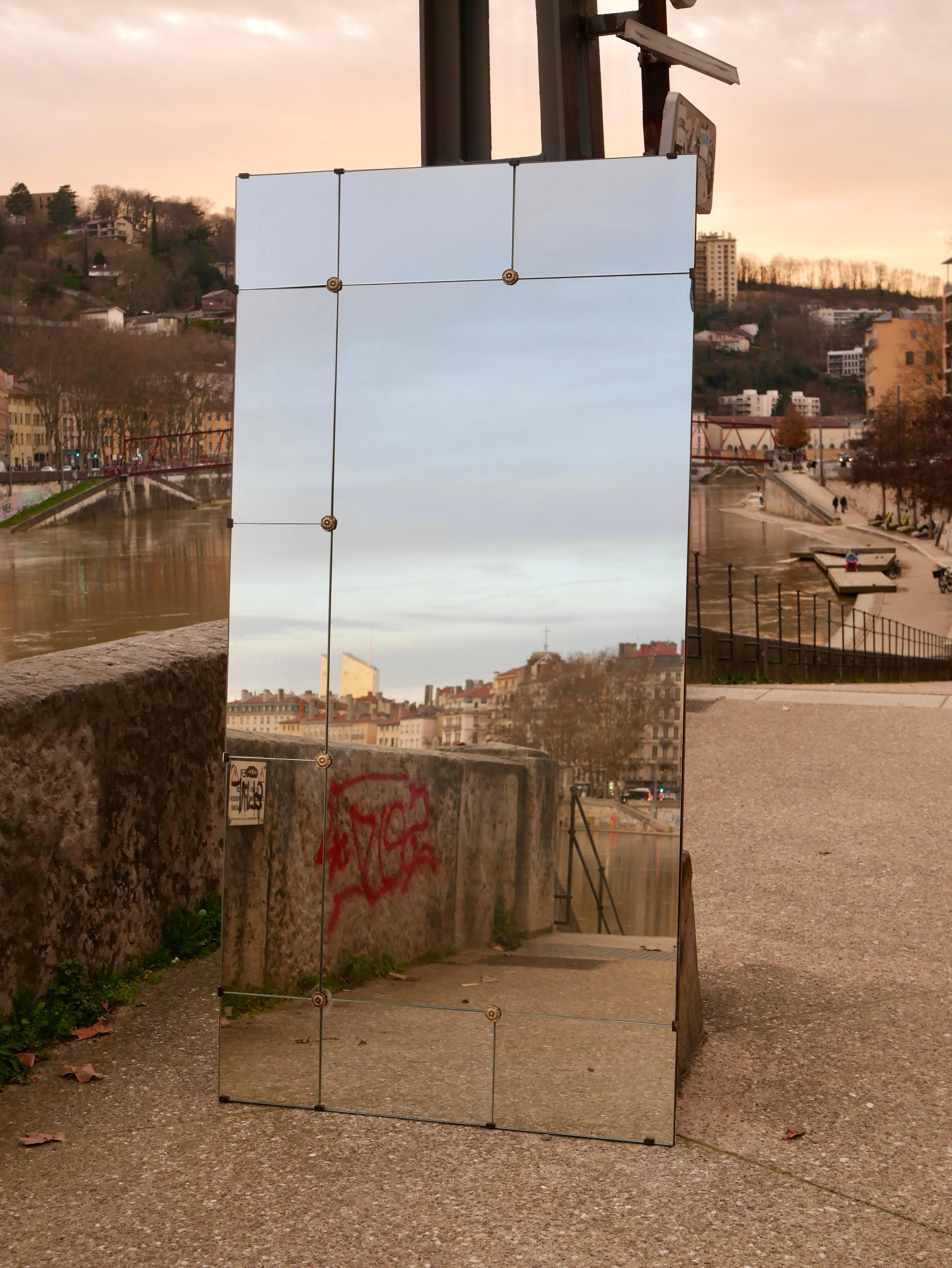 Large brasserie style mirror, from the 1970s, France, to be set horizontally or vertically. 
10 mirrors, flower shaped screws, in brass.
Good condition : one small crack, and one small part missing on the edge (see photos).
Dimensions : W100, H200cm