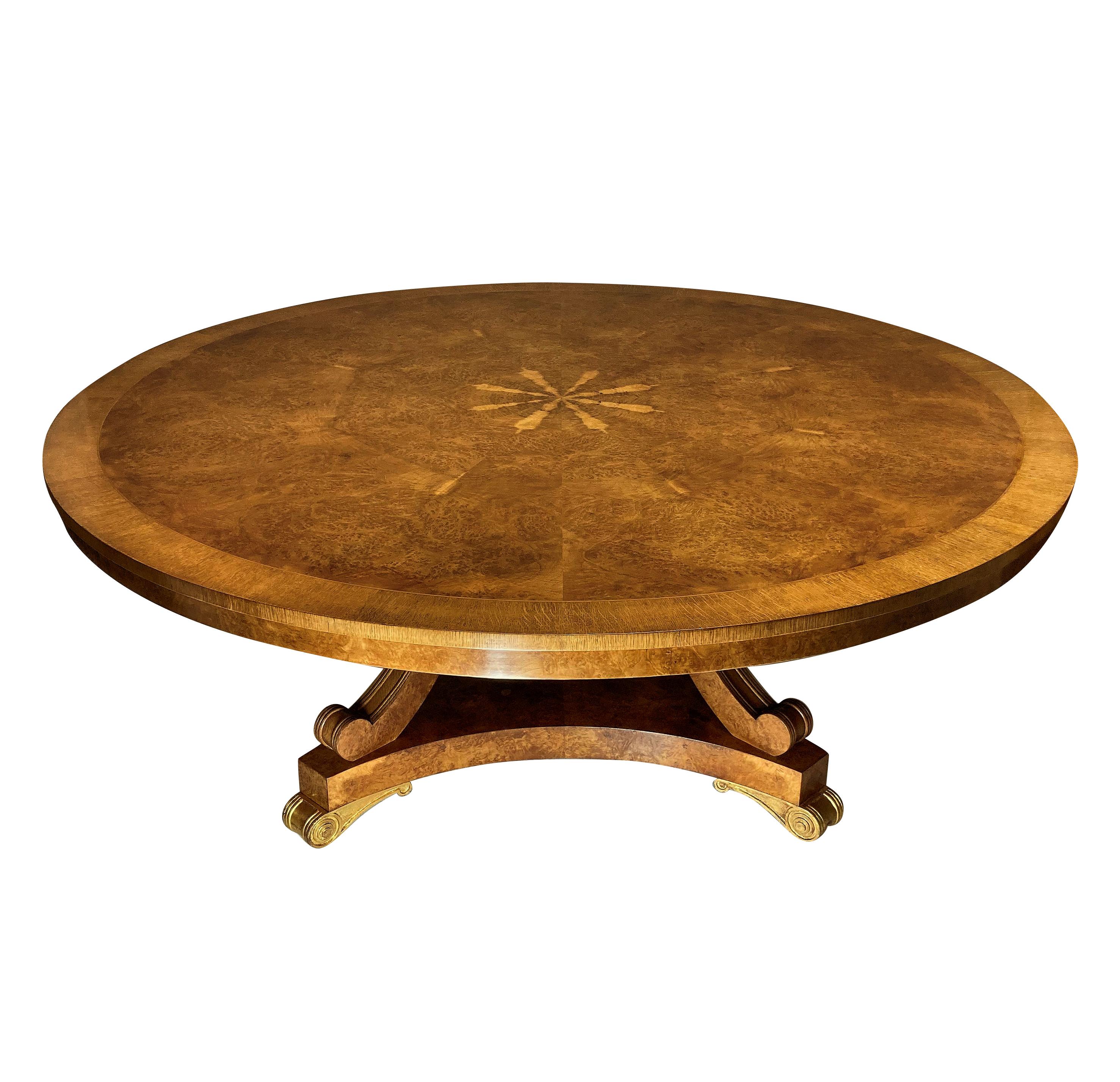 A large English breakfast table in pollard oak in the manner of George Bullock. With fine figuring, the base with water gilded feet and detachable top. This table will seat 8-10 people.