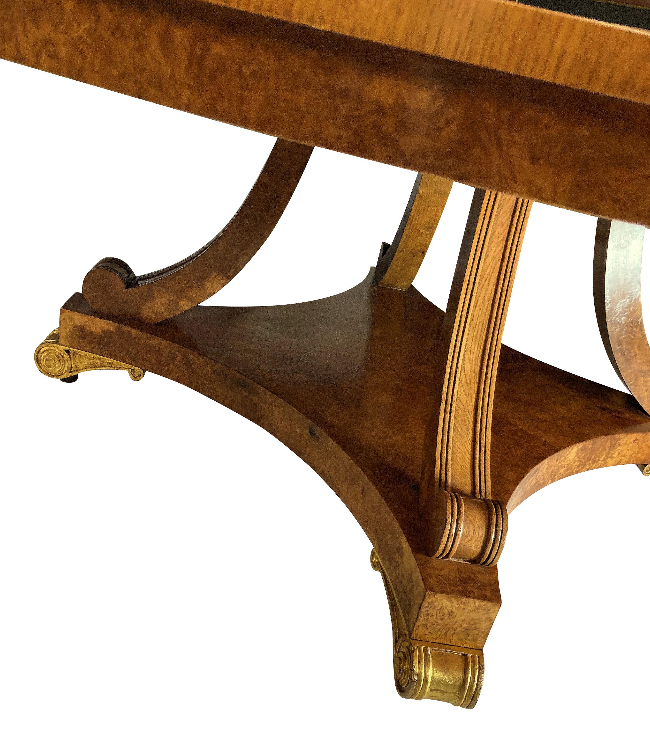 A large English breakfast table in pollard oak in the manner of George Bullock. With fine figuring, the base with water gilded feet and detachable top. This table will seat 8-10 people.
