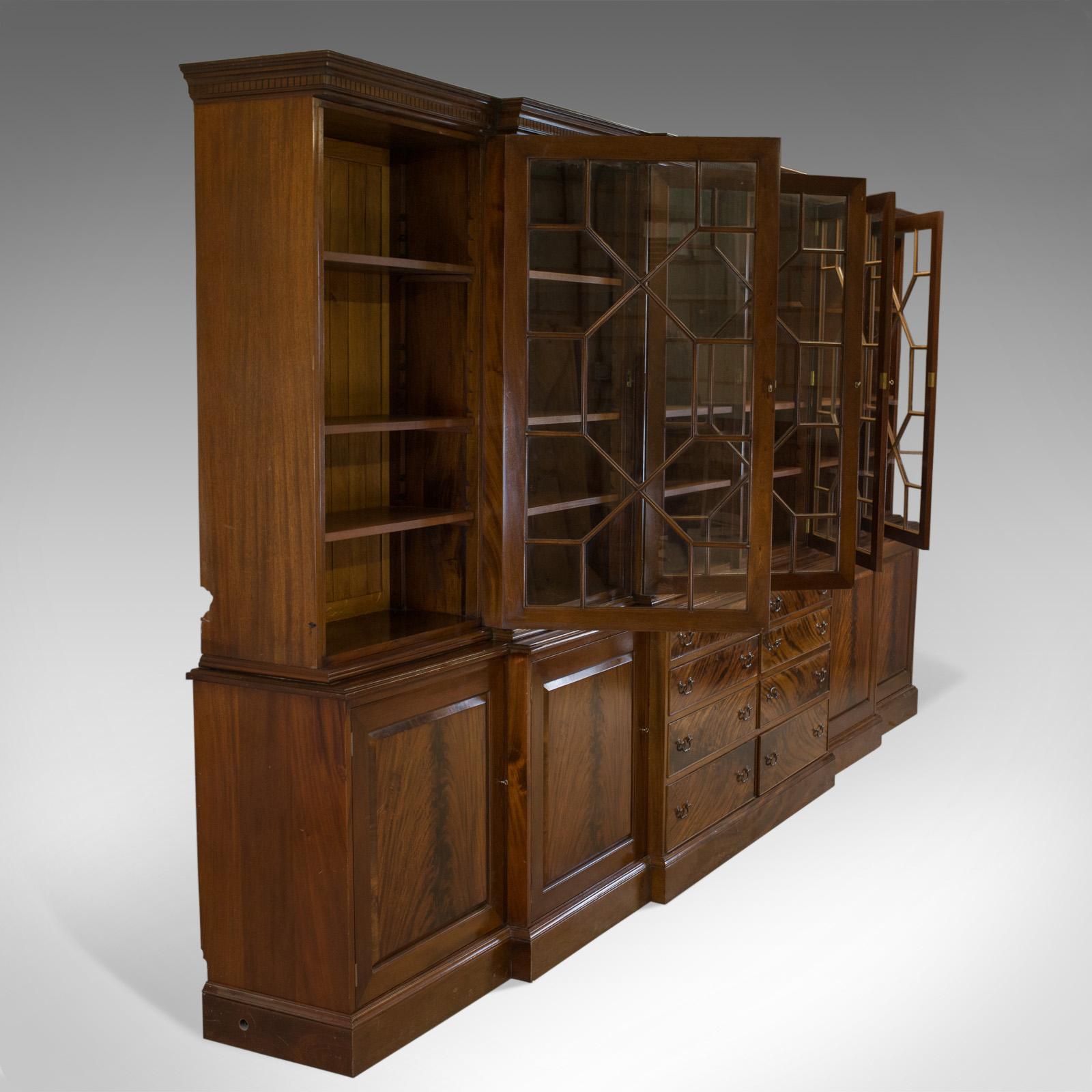 This is a large breakfront bookcase cabinet. A mahogany, glazed, Georgian revival, cabinet crafted in the late 20th century.

Impressive, large bookcase crafted in select mahogany
Good consistent colour throughout with a wax polished finish
In
